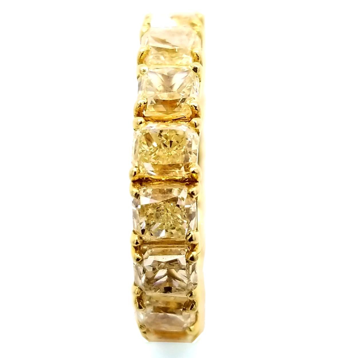 This beautiful Eternity Ring is made in 18K Yellow Gold with 17 perfectly matched Fancy Yellow Radiant Diamonds Set in Shared Prong Mode.
Total Weight of diamonds: 8.45 Ct  VS-SI1/Fancy Yellow
Total Weight of the Ring: 7.66 Gr 18K Yellow Gold
Ring