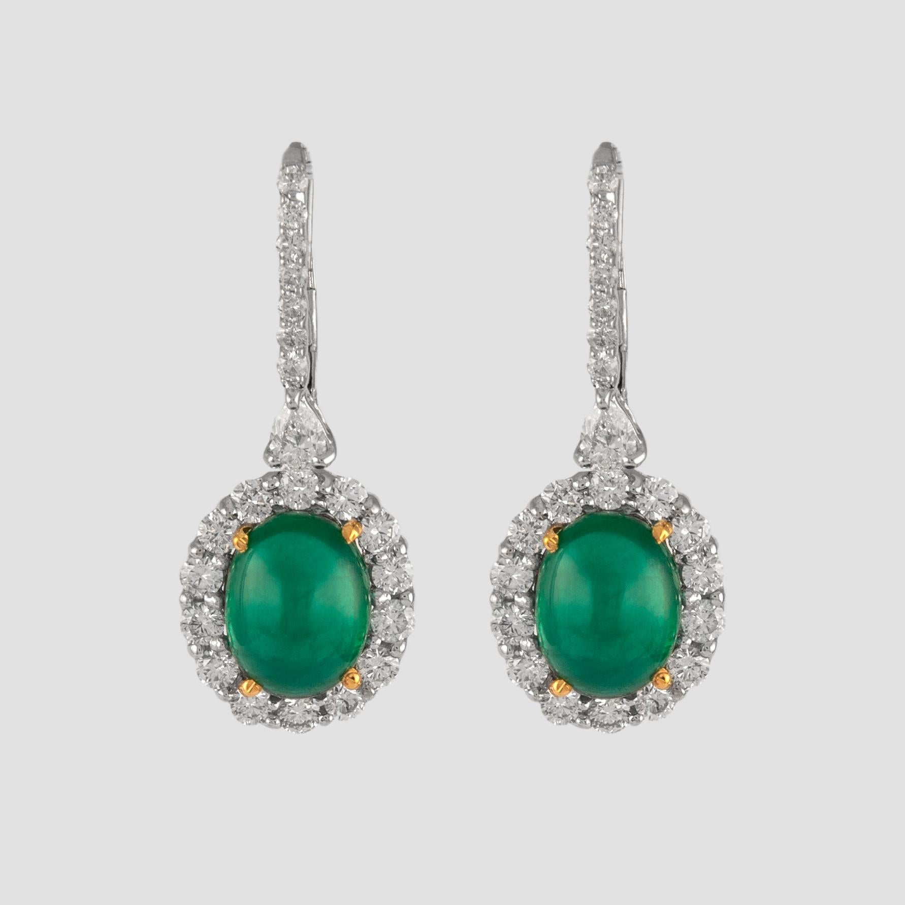 Sensational emerald and diamond drop earrings. Created by Alexander of Beverly Hills.
2 cabochon emeralds, 8.45 carats total. Complimented by 2 pear shape and 42 brilliant diamonds, 2.45 carats. Approximately H/I color and SI clarity. 18k white