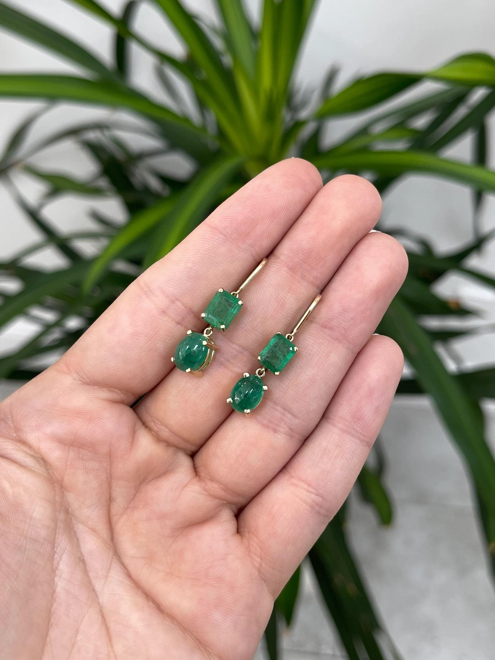 A beautiful pair of natural emerald dangle gold earrings. This interesting pair showcases two stunning natural emerald cut emeralds and two striking cabochon cut emeralds. The earth-mined gemstones display a rare forest-rich green color, with very
