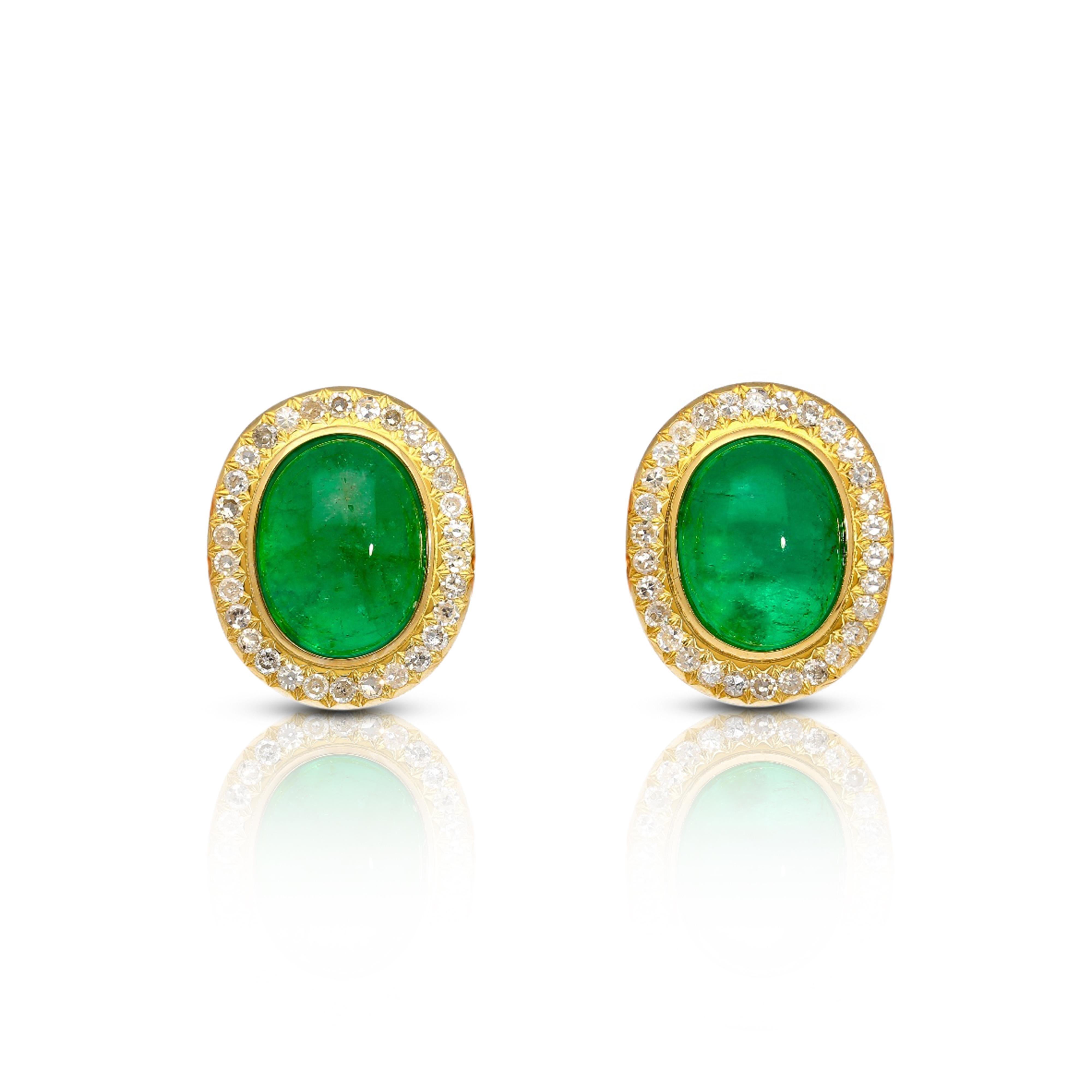 18k yellow gold mounts 8.47 carats of cabochon cut emeralds and 0.72 carats of round cut diamonds to form statement stud earrings. The emeralds display a stunning bright green with excellent luster and transparency. Round cut diamonds form a halo in