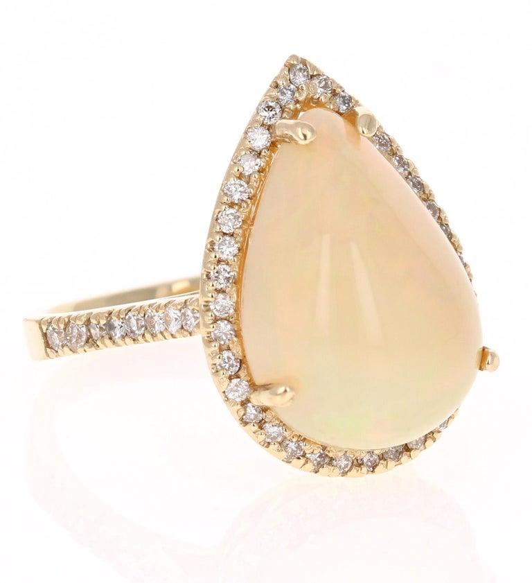 Stunning 8.47 Carat Opal and Diamond Ring that can easily transform into a special occasion ring or even an everyday ring.  
There is a gorgeous 7.85 Carat Pear Cut Opal that is set in the center of the ring. It is surrounded by 52 Round Cut