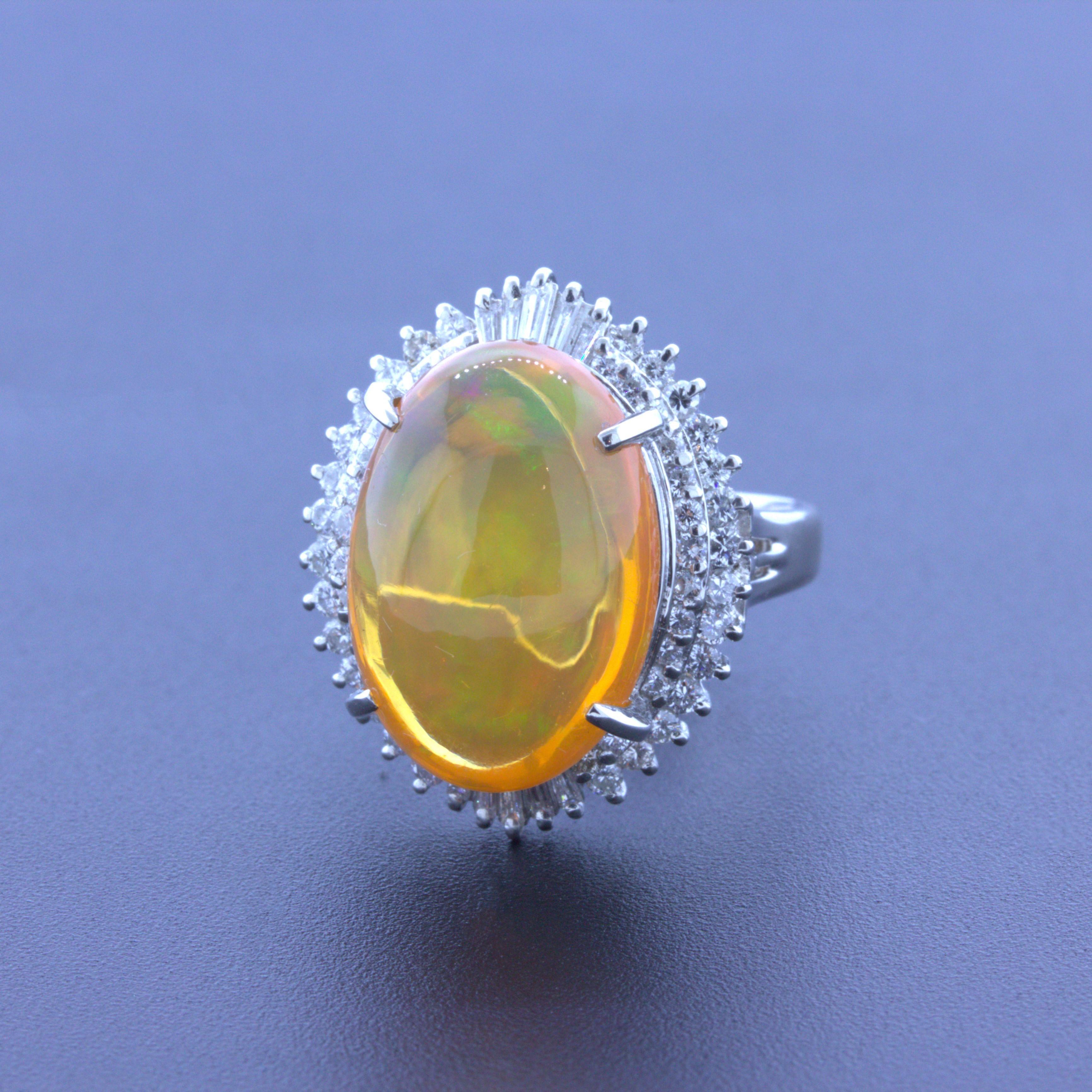 A lovely fire opal ring coming from the mines in Mexico weighing 8.48 carats. The opal has a bright and lively orange color along with excellent play-of-color with flashes of red, orange, green, and yellow all dancing across the stone. It is
