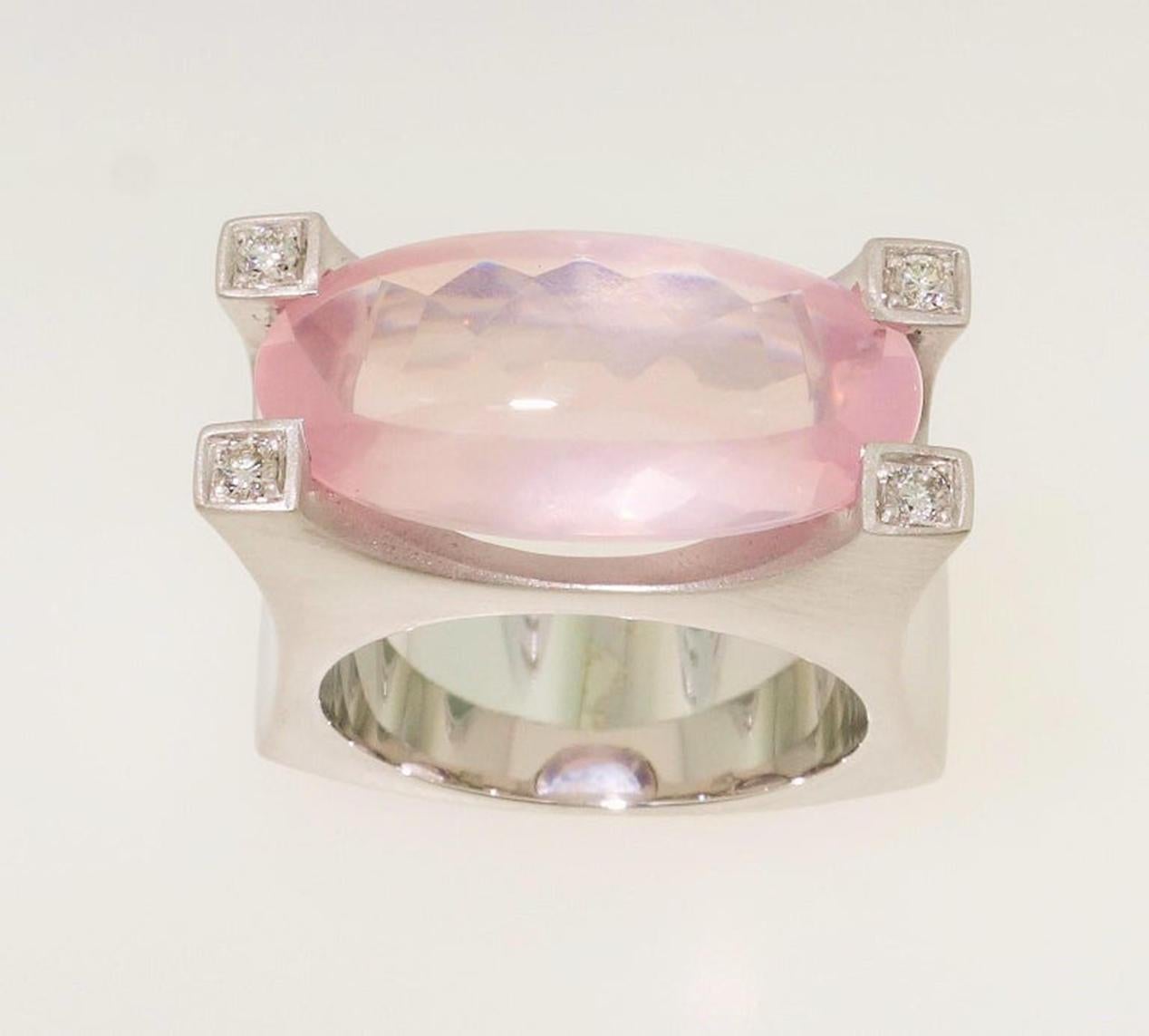 Stunning solitaire Cocktail ring featuring a 8.48 Carat oval Buff-Top Rose Quartz measuring approx. 20mm x 10mm; each corner enhanced with a round Diamond; 4 round Diamonds approx. 0.10 total carat weight; Sterling Silver Tarnish-resistant Rhodium