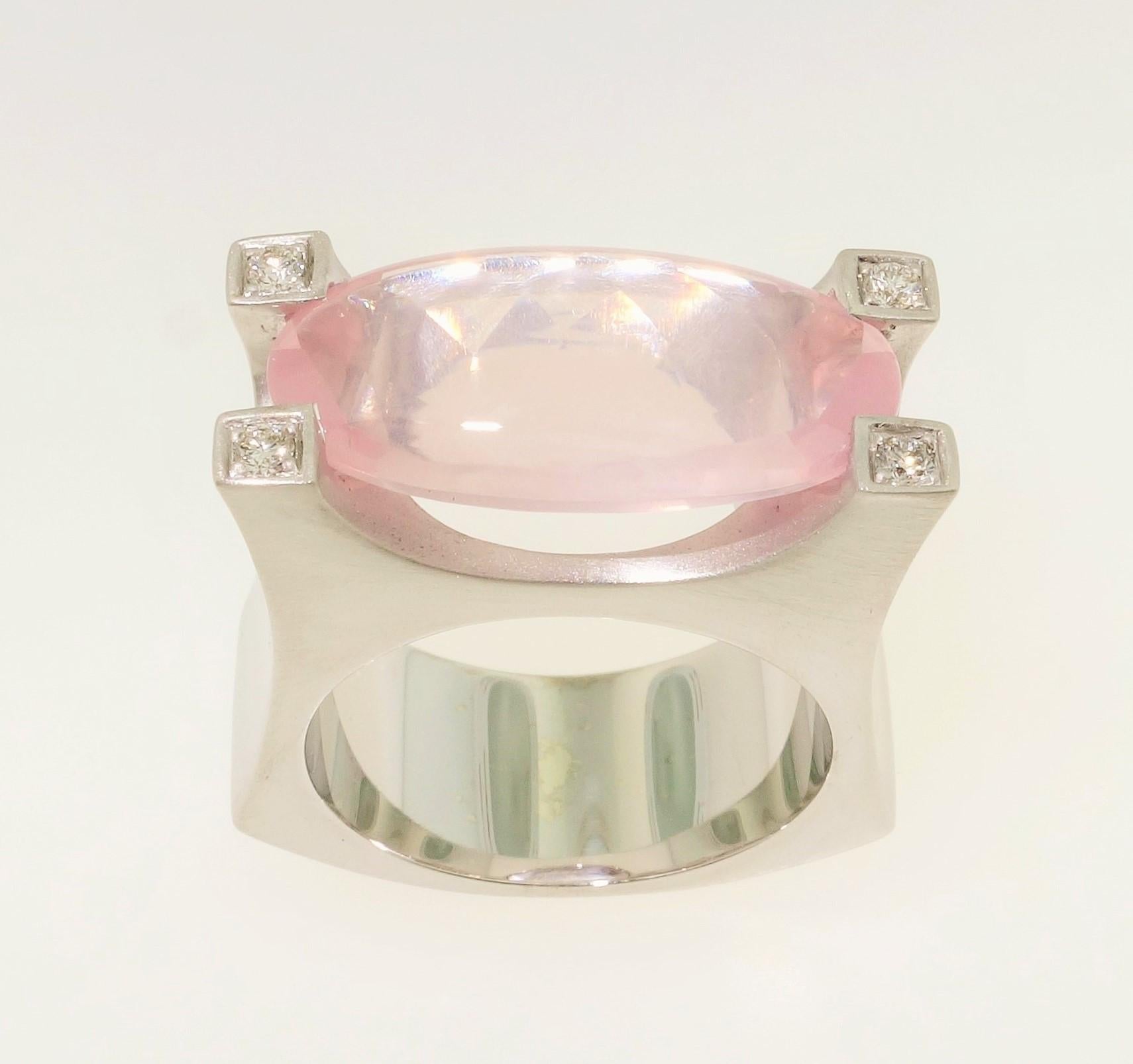 Stunning solitaire Cocktail ring featuring an 8.48 Carat oval Buff-Top Rose Quartz measuring approx. 20mm x 10mm; each corner enhanced with a round brilliant-cut Diamond; approx. total weight of 4 Diamonds:  0.10 carat. Sterling Silver