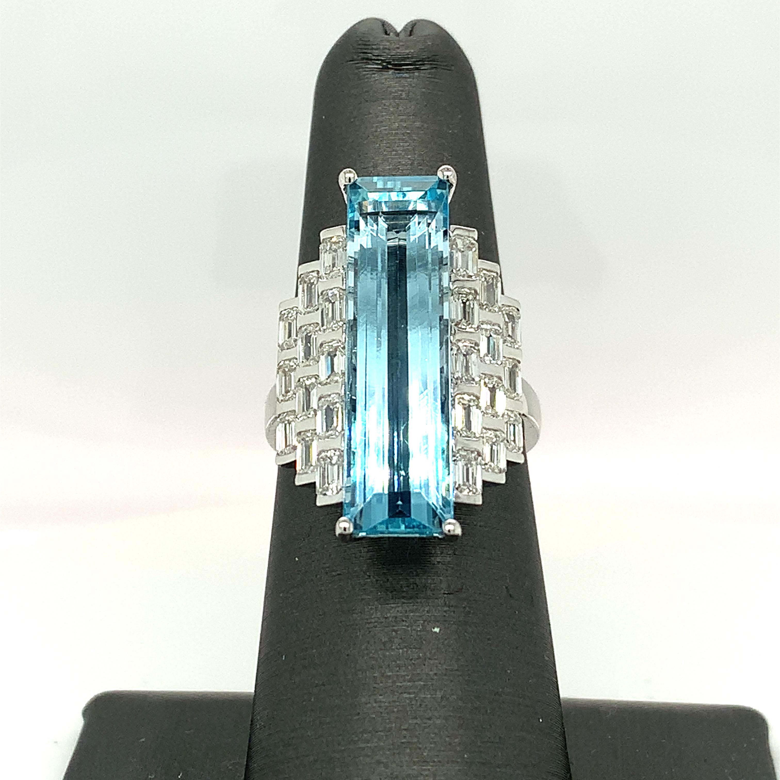 Elongated baguette aquamarine features a line up of 12 pcs baguette diamonds like a brick wall on each side of the center stone. This deco style magnificent cocktail ring is handcrafted by skilled artisans. 
Aquamarine: 8.49 carat
Diamond: 2.12