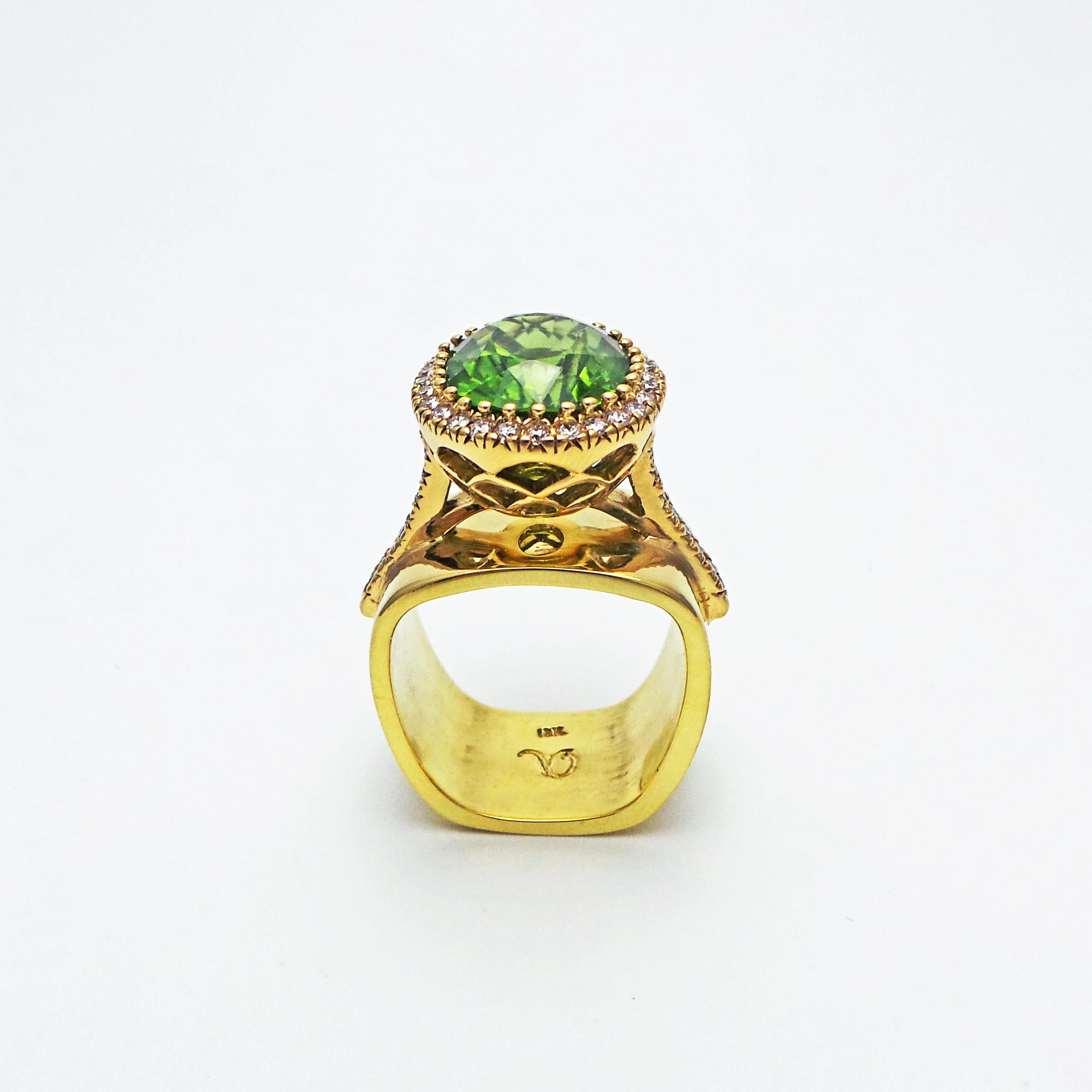 8.49 carat oval Burmese Peridot with Diamond halo and accents (weighing a total of .55 carat, SI1 in clarity, G in color) set in 18k yellow gold with scalloped undercarriage, and mounted on a solid 18k yellow gold square band. Size 7. This Burma