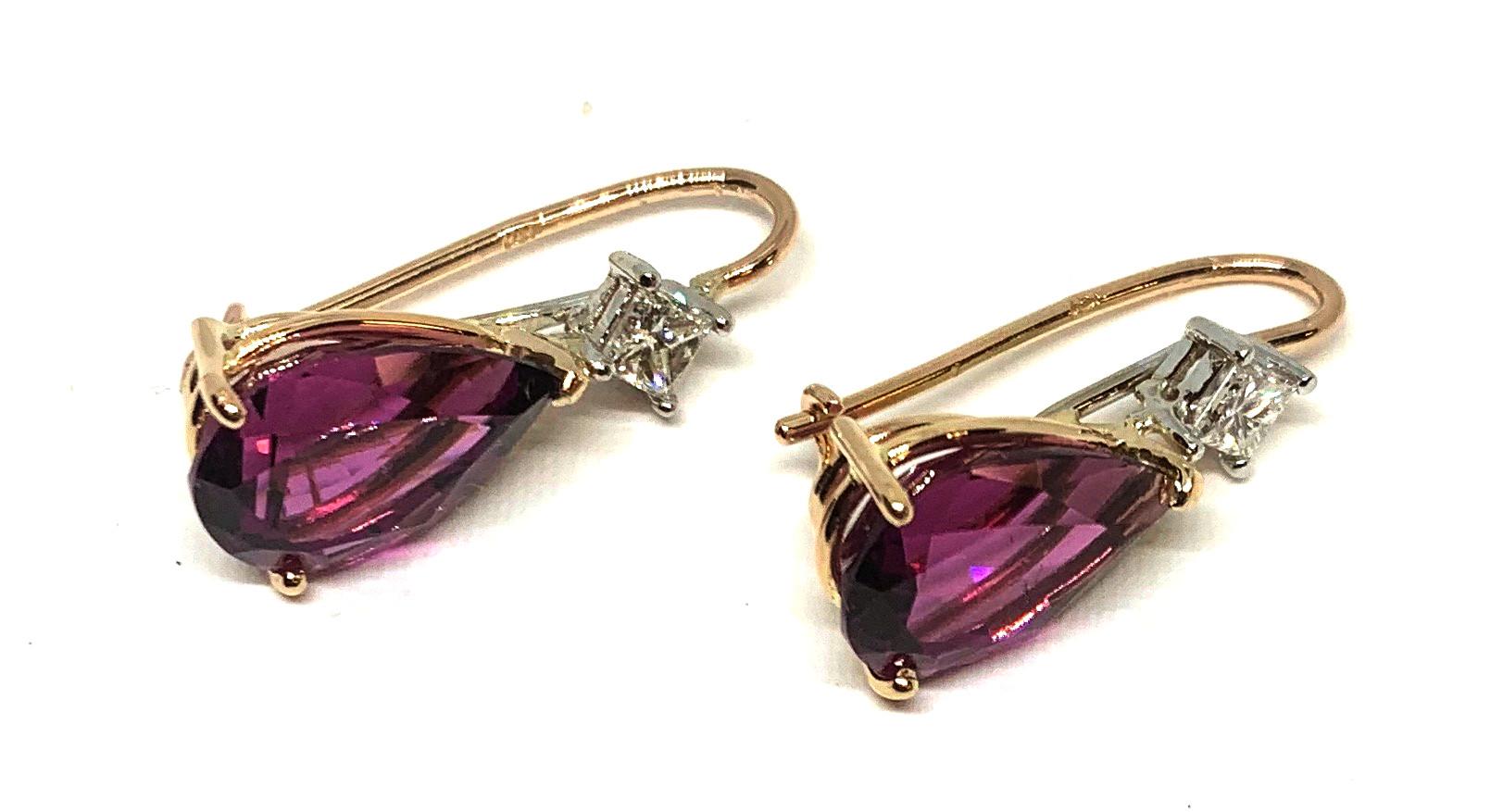 These earrings feature beautiful raspberry-red rhodolite garnets. They are a perfectly matched pair of large pear-shaped stones. Most large colored stones that are a perfect match for color and shape are hard to find. As a result, they are never