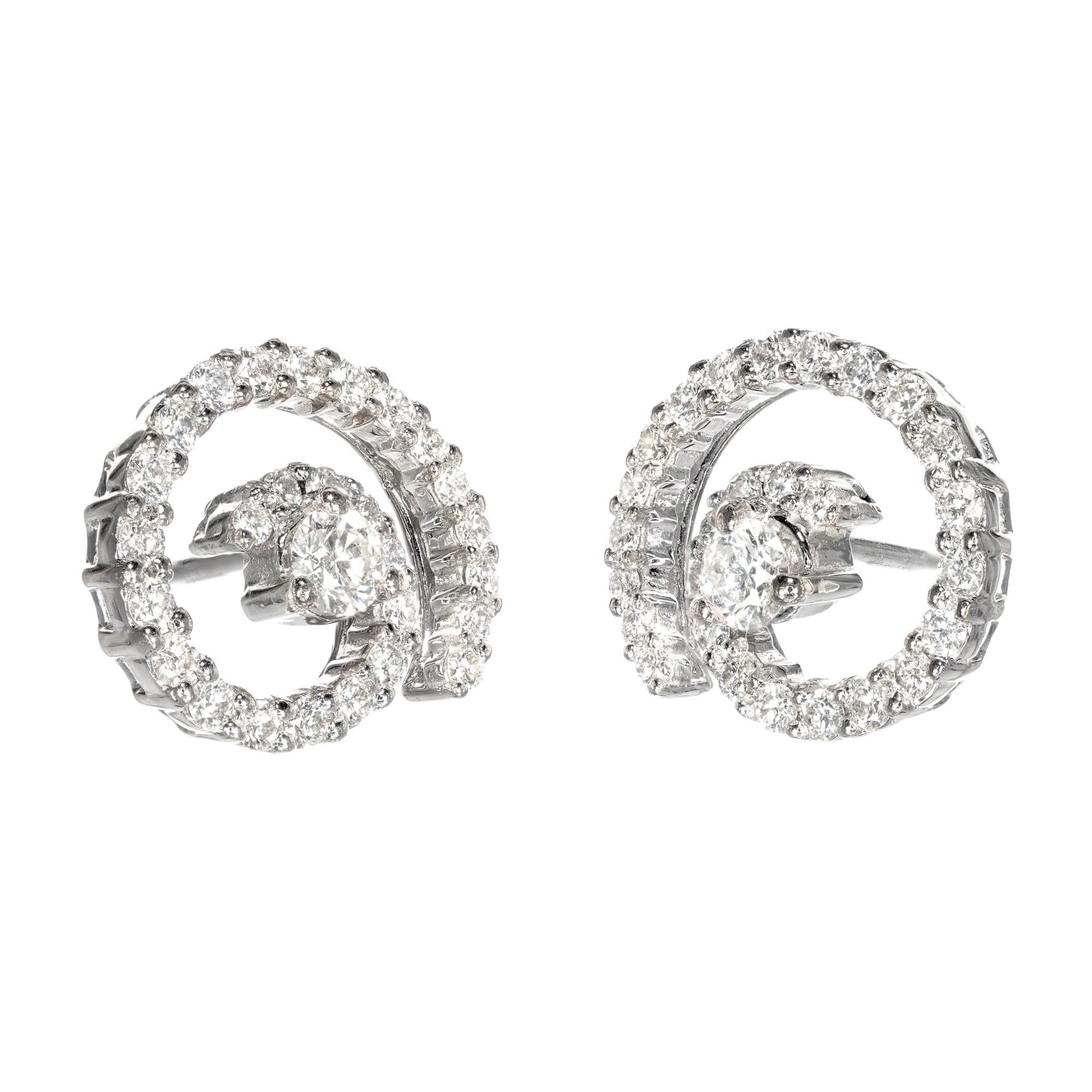 18k white gold Diamond earrings with center Diamond stud set in white gold and surrounded by an open swirl of Diamonds.

2 round brilliant cut Diamonds, approx. total weight .18cts, G – H, VS, 2.9mm
54 round brilliant cut Diamonds, approx. total