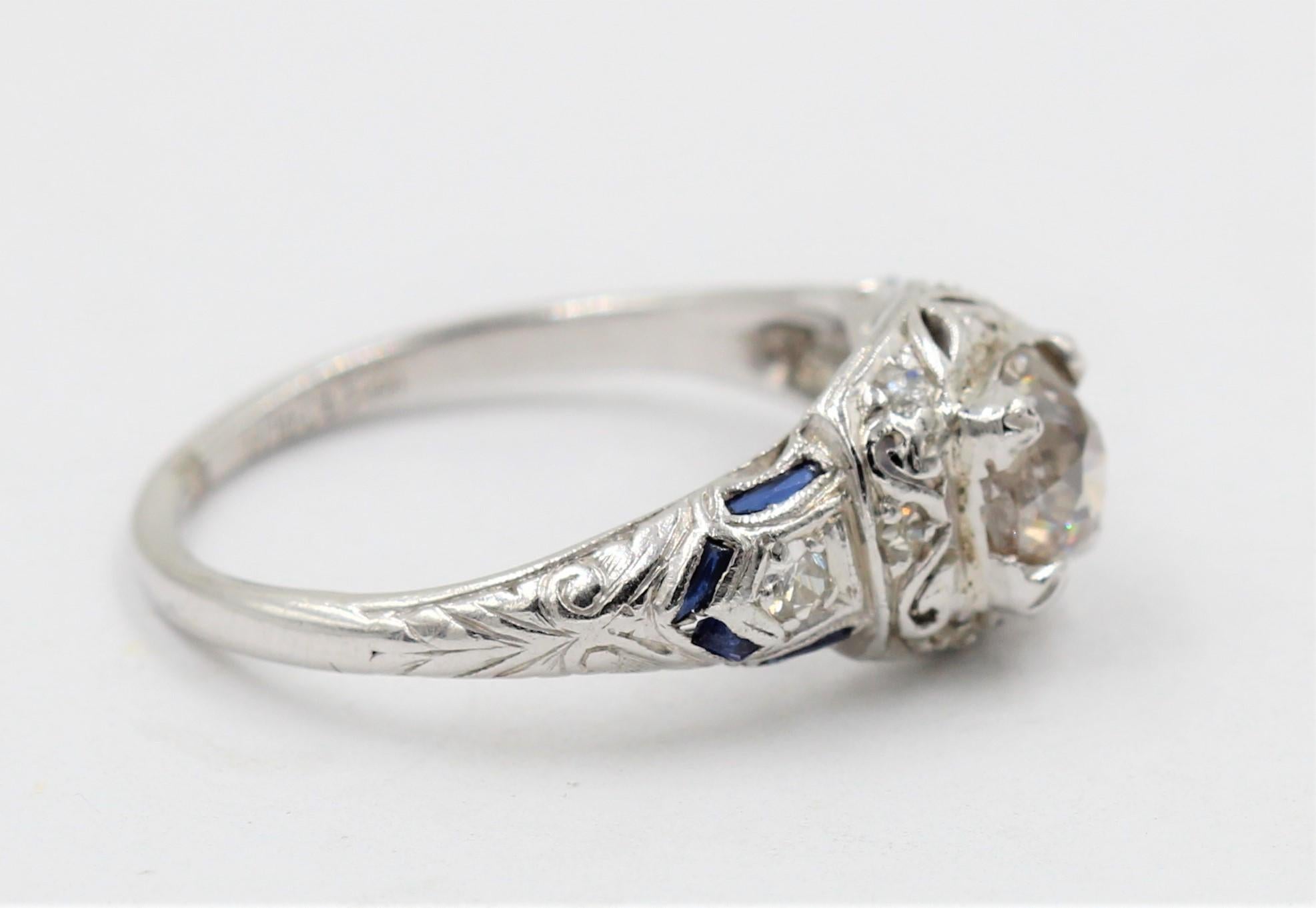 
This gorgeous platinum diamond ring features .85ct  Old European Round Cut Diamond.
The diamond is graded J color and I3 clarity.
The sides include 8 round diamonds tw .30ct and 8 baguette cut sapphires .
The ring is size 7 .


