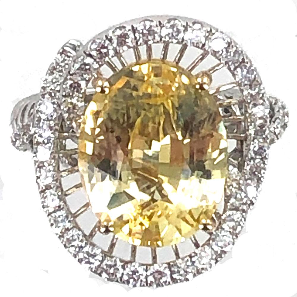 Gorgeous 8.54 Carat Oval Yellow Sapphire Diamond Ring. The natural yellow sapphire has no heat treatment and has a certificate from the GIA. The sapphire is surrounded by 50 round brilliant cut diamond weighing approximately 1.00 carat total weight
