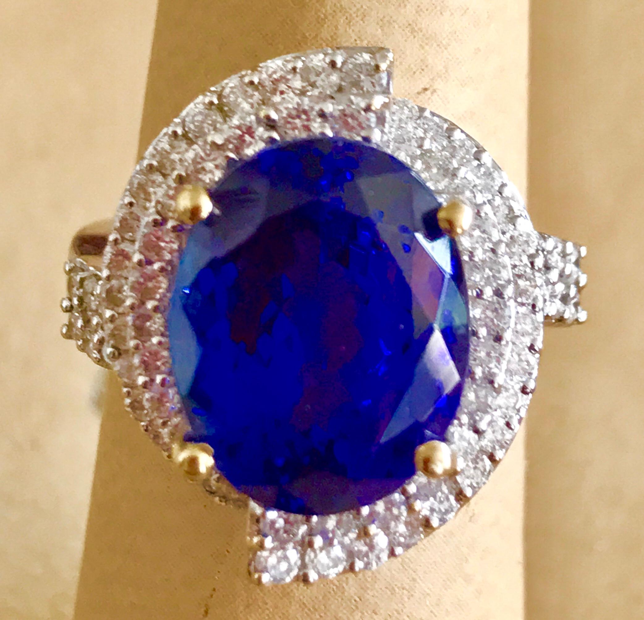 This extraordinary 8.5 carat tanzanite is a true gemstone that is highly treasured. It is surrounded by a total of 2.0 carats of shimmering white diamonds, which adds to the overall beauty and elegance of the piece. The oval-cut gem exhibits the