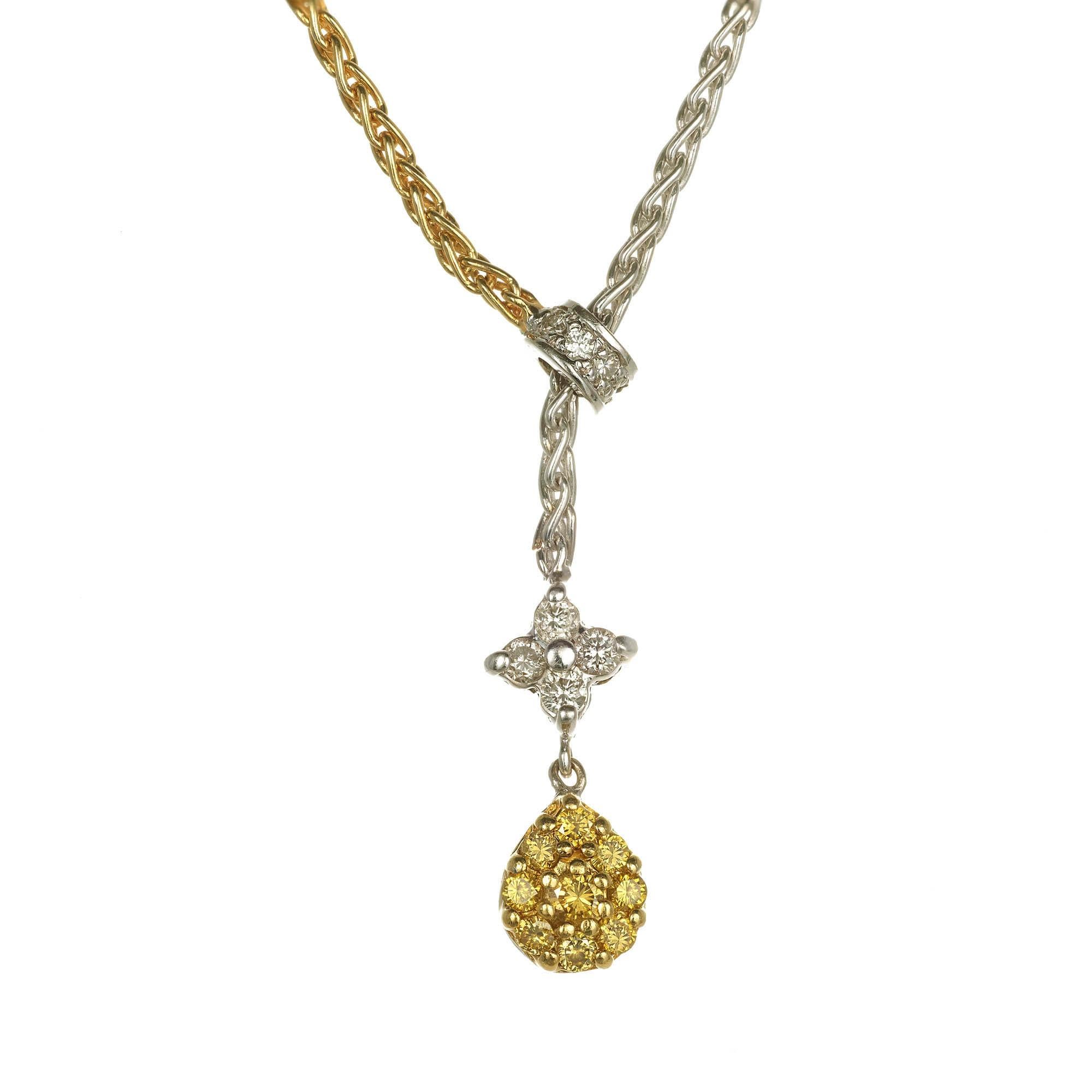 18k Two tone diamond design necklace. An 18k yellow gold 8 inch chain by a diamond set rondelle that slides up and down white gold chain. The white gold chain also suspends a diamond set star and drop pendant which has alternating sides of fancy