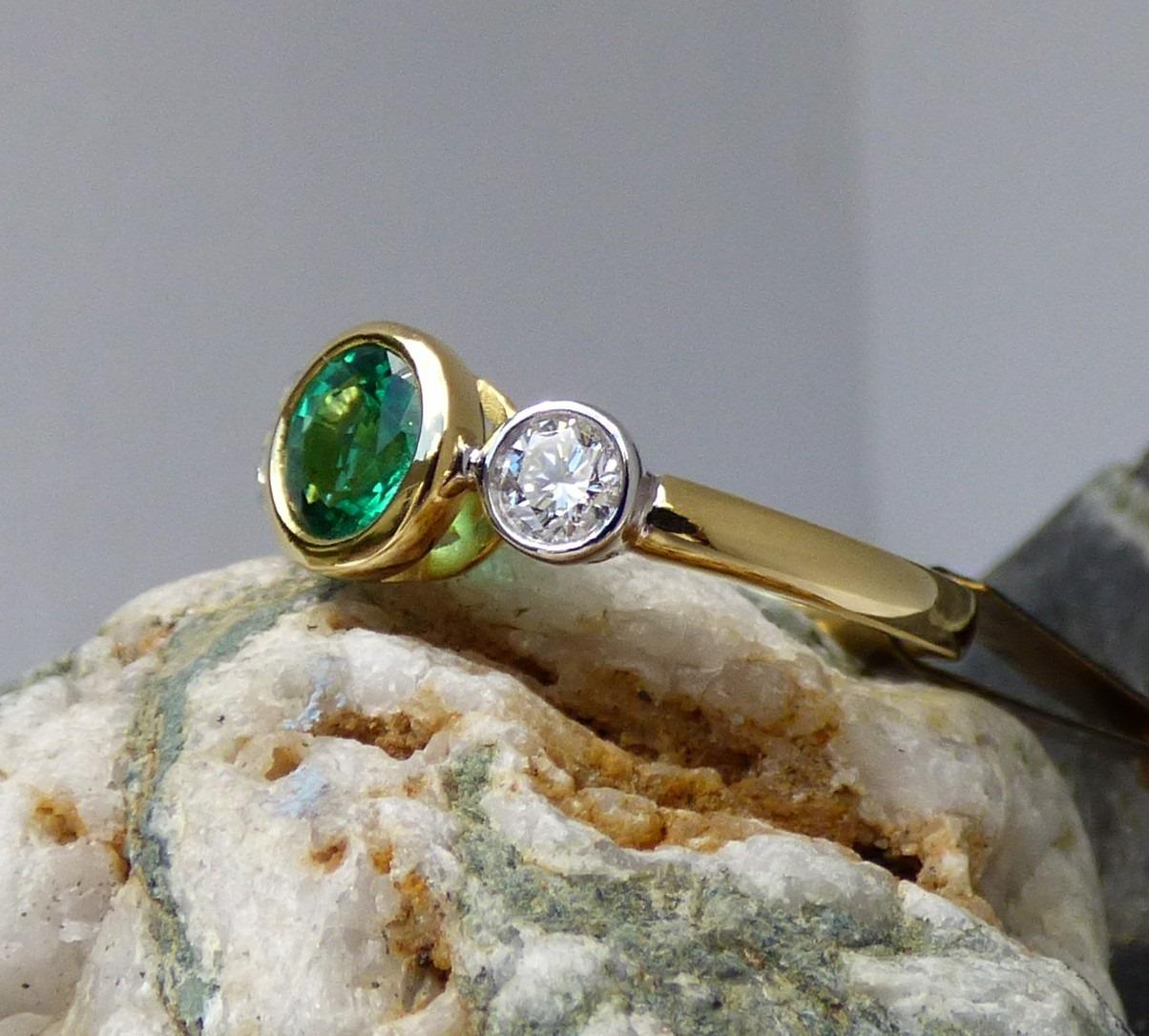 Contemporary .85 ct. Round Emerald and Diamond Three Stone ring in 18K Gold For Sale