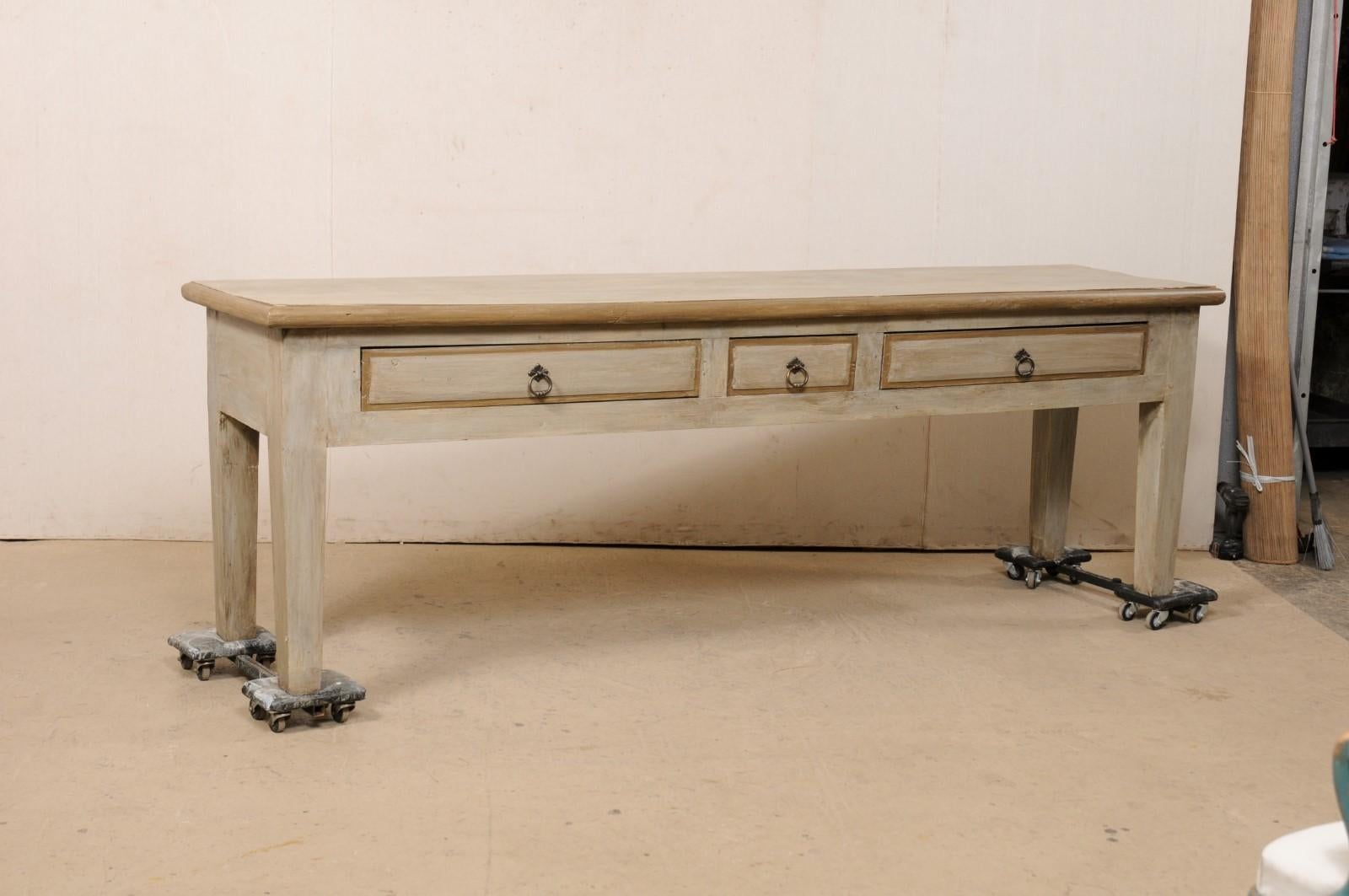 A large console table, which has been fashioned from old reclaimed wood from Brazil. This table has been designed in simple, clean lines. Its slightly overhanging, rectangular-shaped top, approximately 8.5+ foot long, rests atop an apron which
