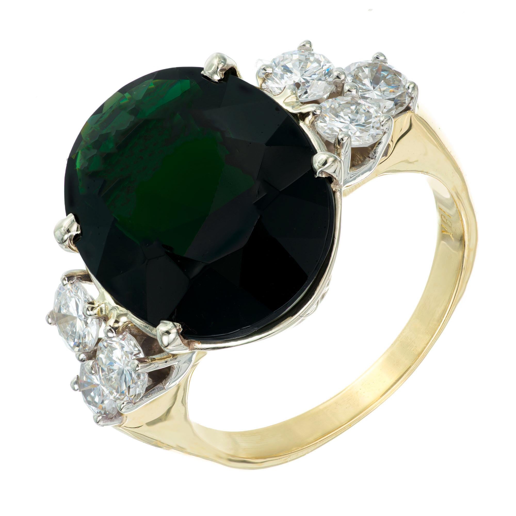 Deep large oval green Tourmaline and diamond cocktail ring. Handmade 18k yellow and white gold setting with 3 bright brilliant cut diamonds on each side.  

1 Natural green 16.7 x 13.2 x 699mm Tourmaline, approx. 8.50 cts
6 brilliant cut diamonds