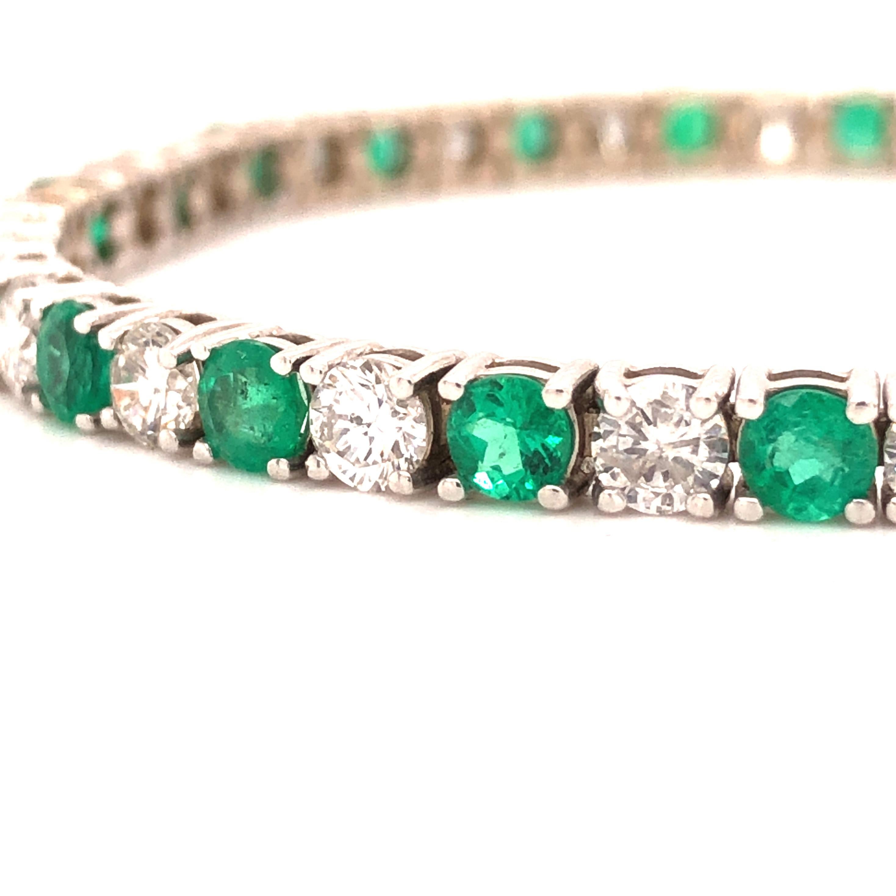 Offered here is a classic Emerald and Diamond straight-line bracelet. 
24 round natural earth mined green Colombian Emeralds weighing 4.25 carats total, amazing crystal gem quality with natural inclusions, interchanged with 24 natural earth mined