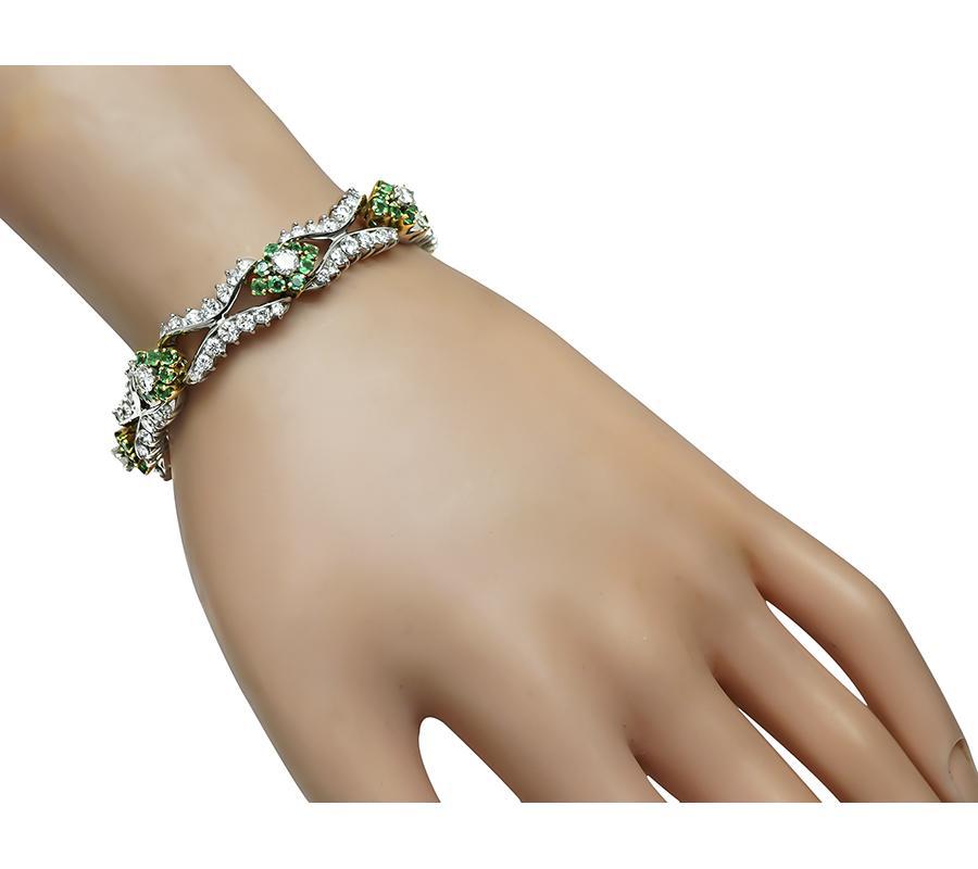 This is a stunning 14k white and yellow gold bracelet. The bracelet is set with sparkling round cut diamonds that weigh approximately 8.50ct. The color of these diamonds is E with VS clarity. The diamonds are accentuated by lovely round cut emeralds