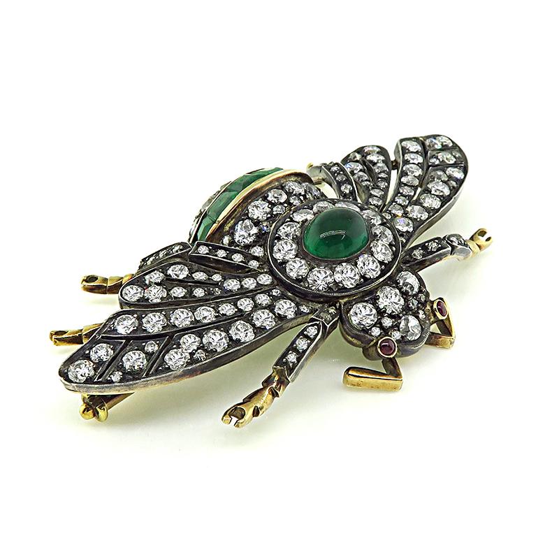 This is an amazing silver and gold bee pin. The pin is set with sparkling old mine cut diamonds that weigh approximately 8.50ct. The color of these diamonds is H with VS2 clarity. The diamonds are accentuated by lovely cabochon and square cut