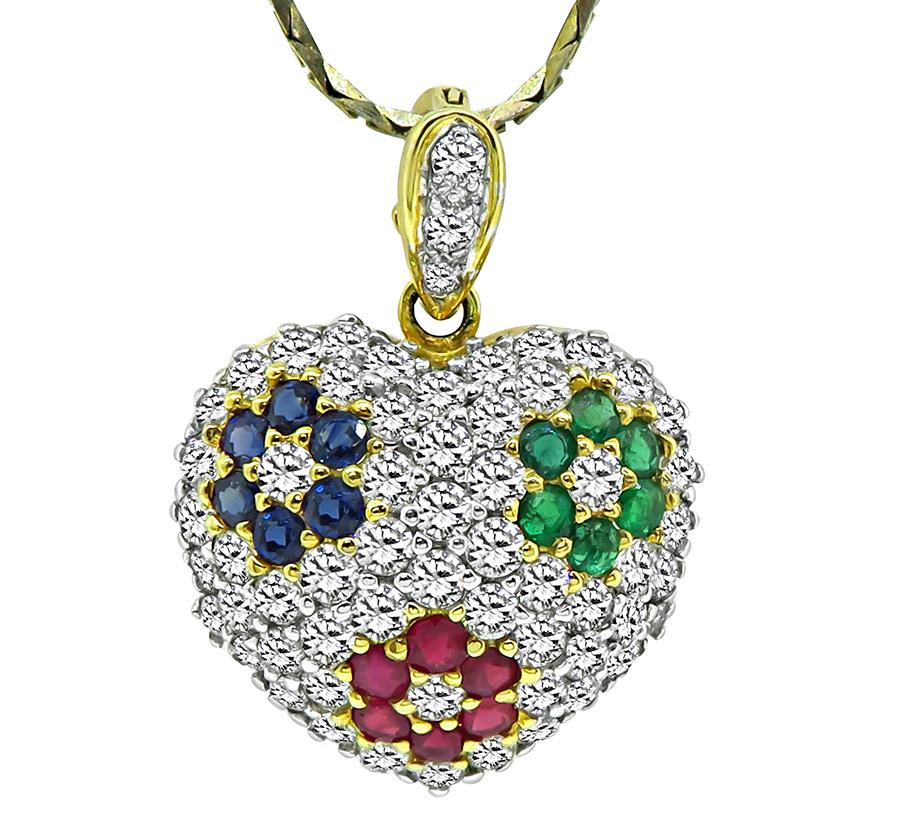 This is a gorgeous 18k yellow and white gold heart pendant and earrings set. The set features sparkling round cut diamonds that weigh approximately 8.50ct. The color of these diamonds is E-F with VS clarity. The diamonds are accentuated by round cut