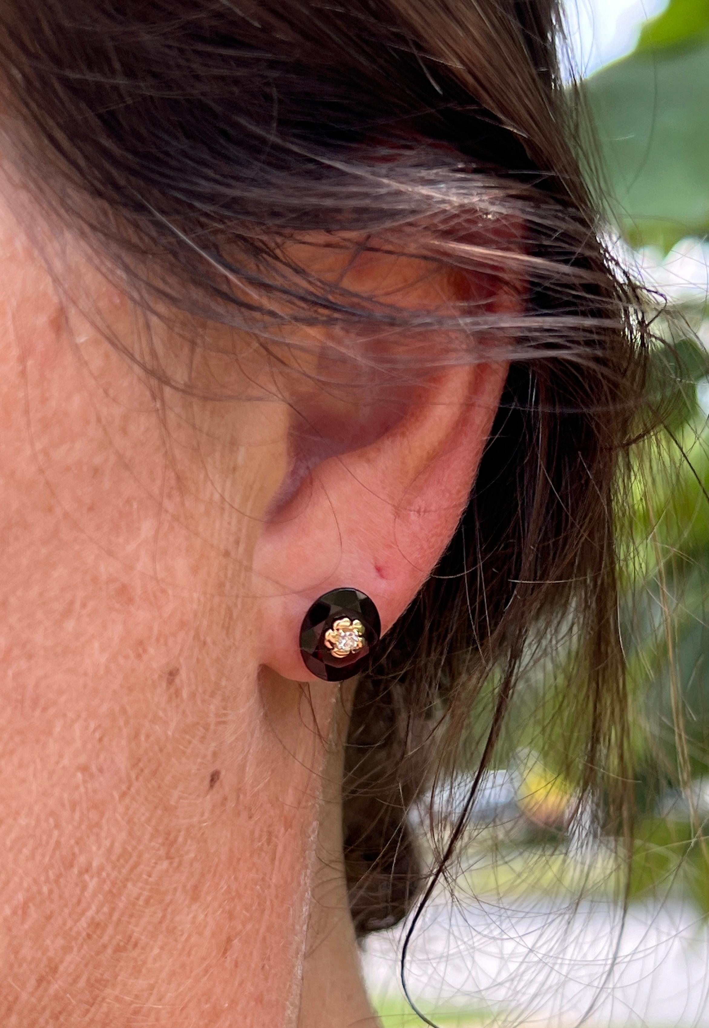 Einen Hauch von moderner Eleganz verleiht dieses atemberaubende Paar von  8,52 Karat tiefrote ovale Granate, jeweils 11x9 mm groß. Akzentuiert durch ein Blumendesign aus 14-karätigem Gelbgold mit je einem runden Brillanten von Farbe H und Reinheit