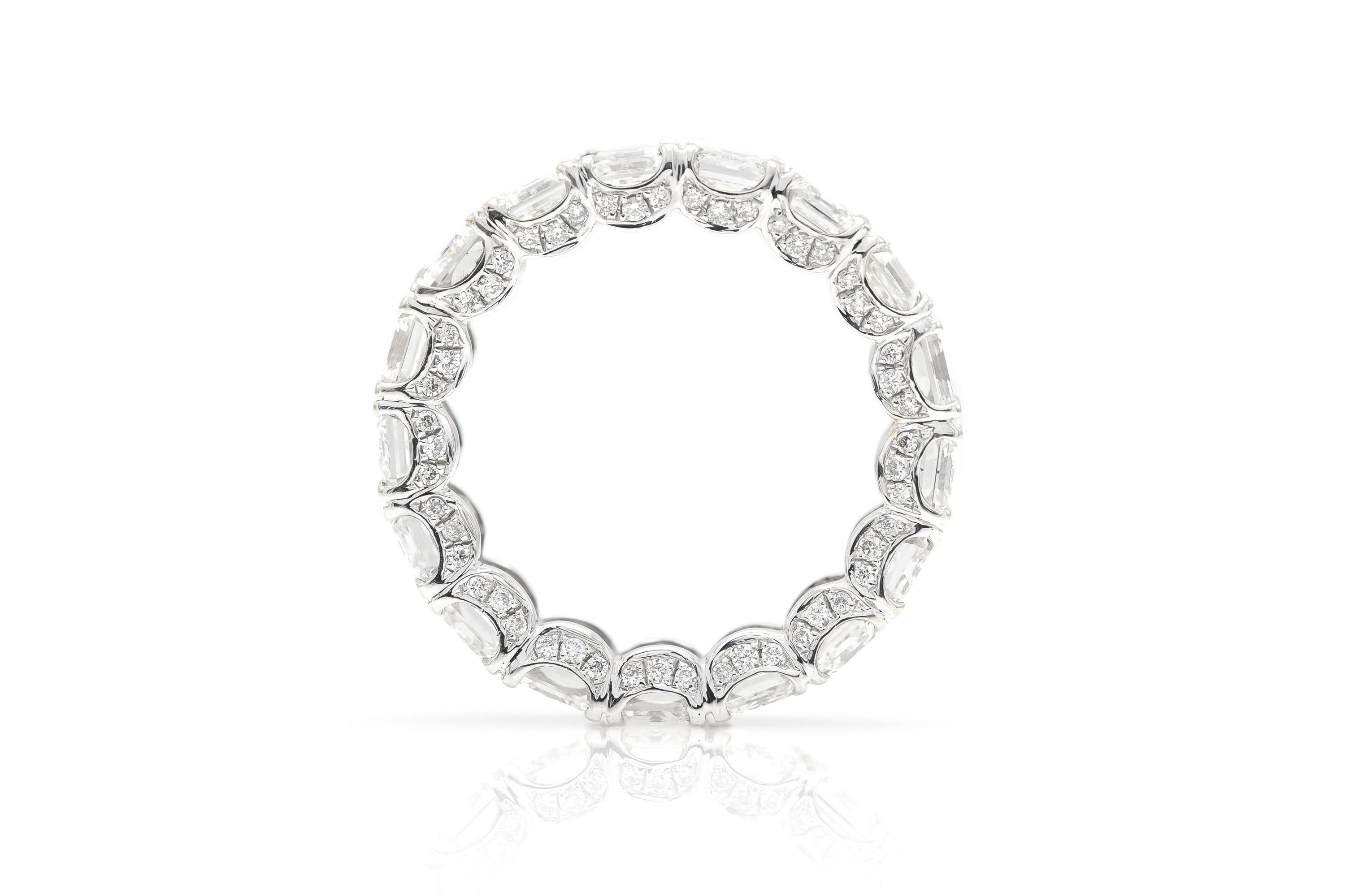 Finely crafted in 18k white gold with 17 GIA certified Emerald cut Diamonds weighing a total of 8.54 carats, E color, VVS1-VS2 clarity.
The ring features accenting Round Brilliant cut diamonds on the setting.
5.5 mm wide
Size 5 1/2
Comes with its