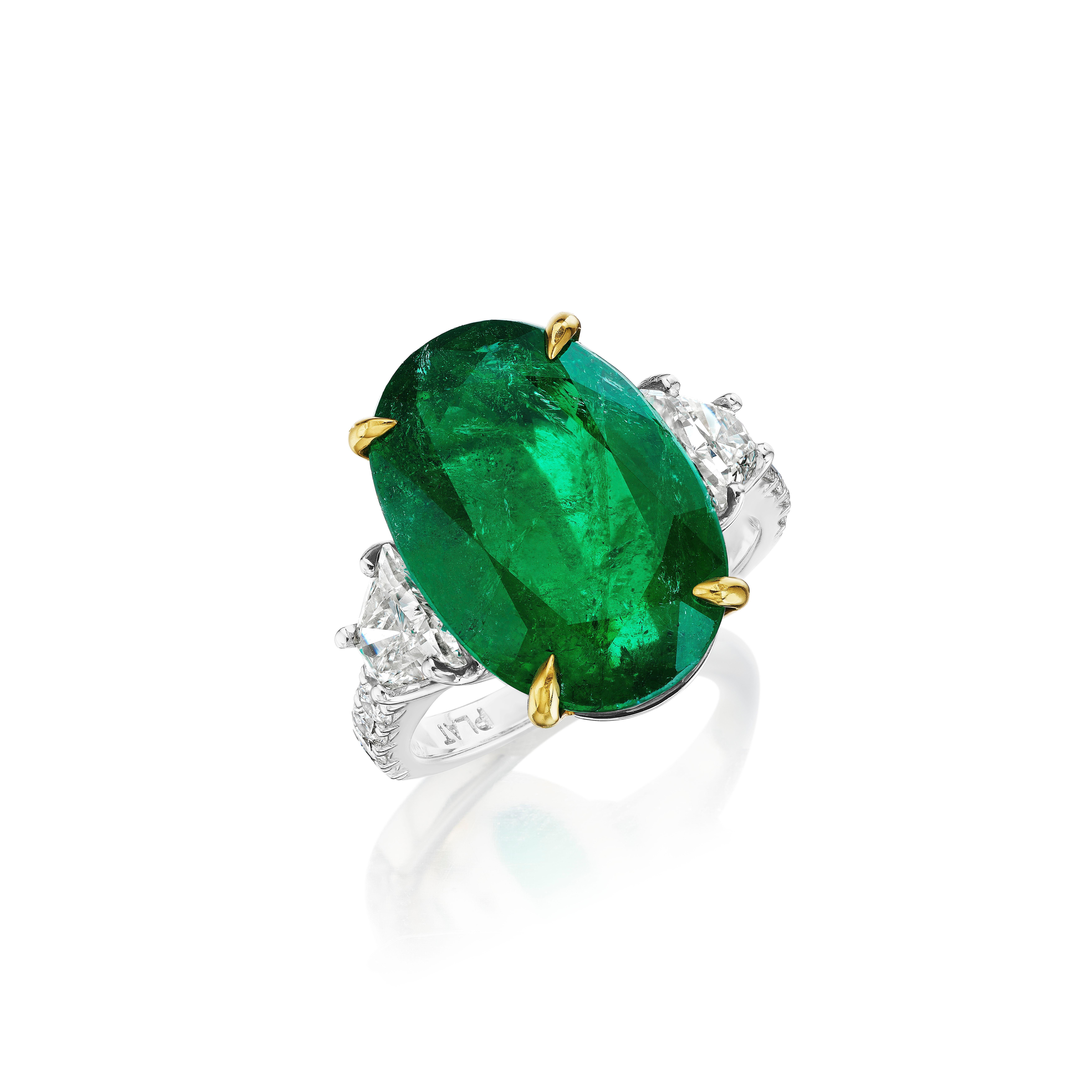 •	Platinum & 18KT Two Tone
•	Size 6.5
•	9.68 Carats

•	Number of Oval Emeralds: 1
•	Carat Weight: 8.54ctw
•	16.80 x 11.70mm

•	Number of Brilliant Trapezoid Diamonds: 2
•	Carat Weight: 0.64ctw

•	Number of Round Diamonds: 10
•	Carat Weight: