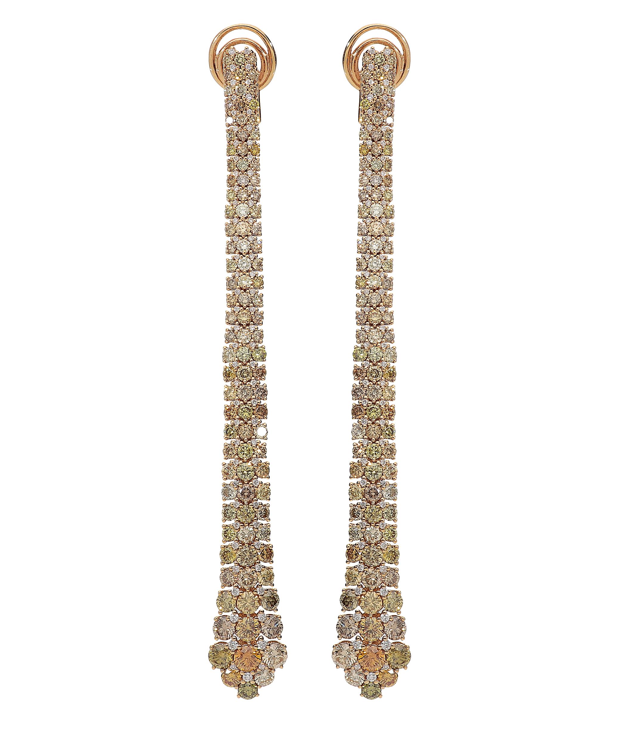 Stunning long dangle earrings in 18kt pink gold for 18,00 grams and a length of 9 centimeters.
Diamonds are 0,59 carat of white round brilliant color G clarity SI and 8.55 carats of multi colored round brilliant in a mix of nuances that catches the