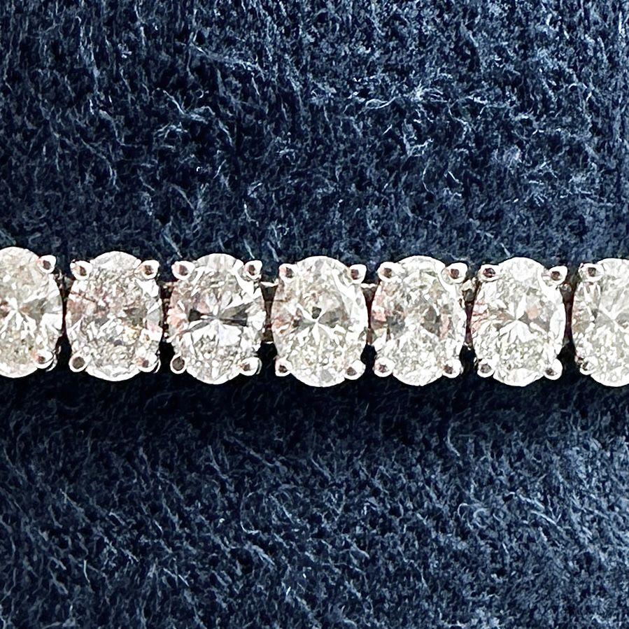 This oval diamond north-south tennis bracelet is a true masterpiece of modern design, crafted in luxurious 18K white gold. Featuring 57 meticulously matched oval cut diamonds, the bracelet totals an impressive 8.58 carats. The north-south