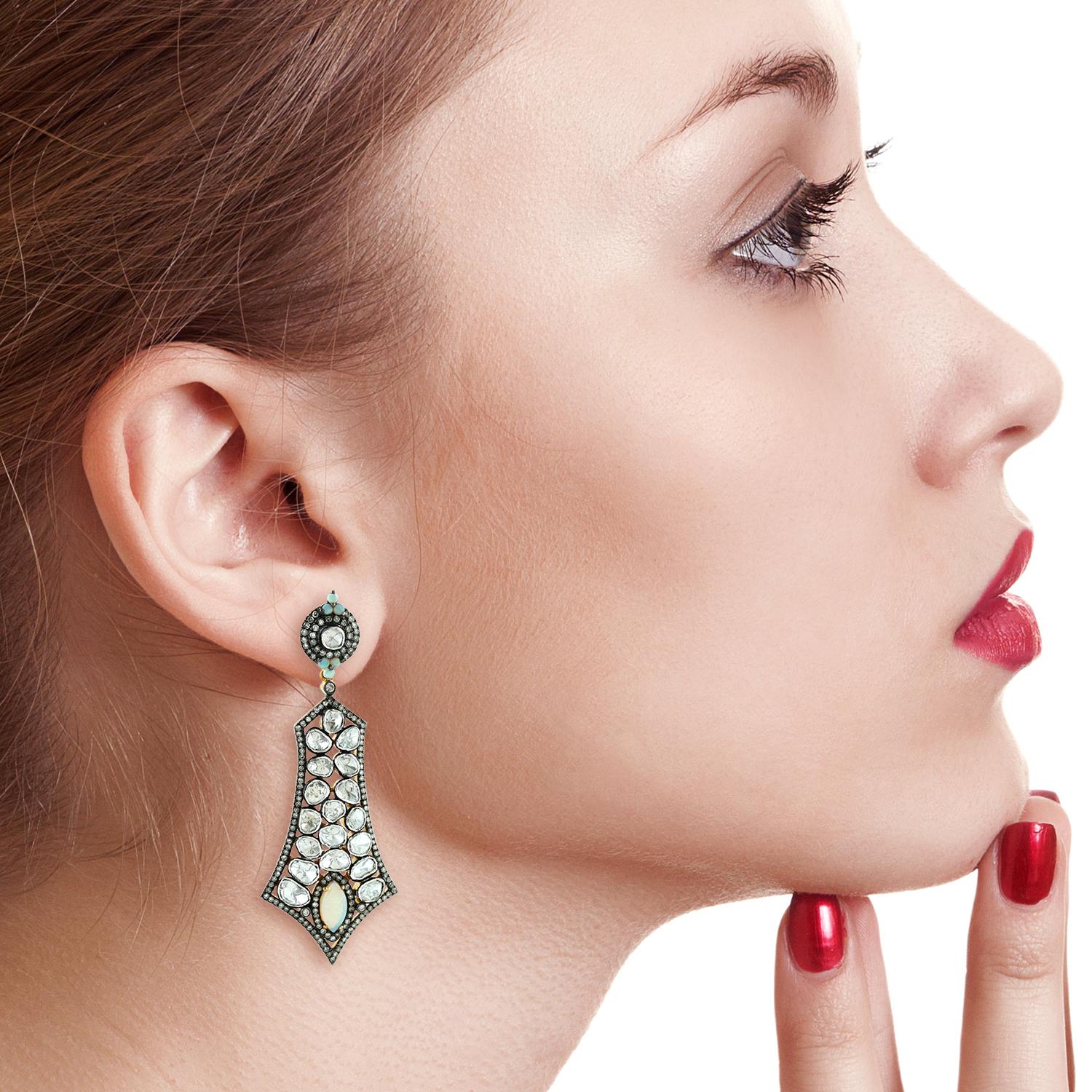 Inspired by the Mughal Era & Royal heritage these stunning earrings are handcrafted in 18-karat gold & sterling silver.  They have a chandelier-style silhouette that's encrusted with 1.84 carats Ethiopian opal and 8.59 carats rose cut diamonds with
