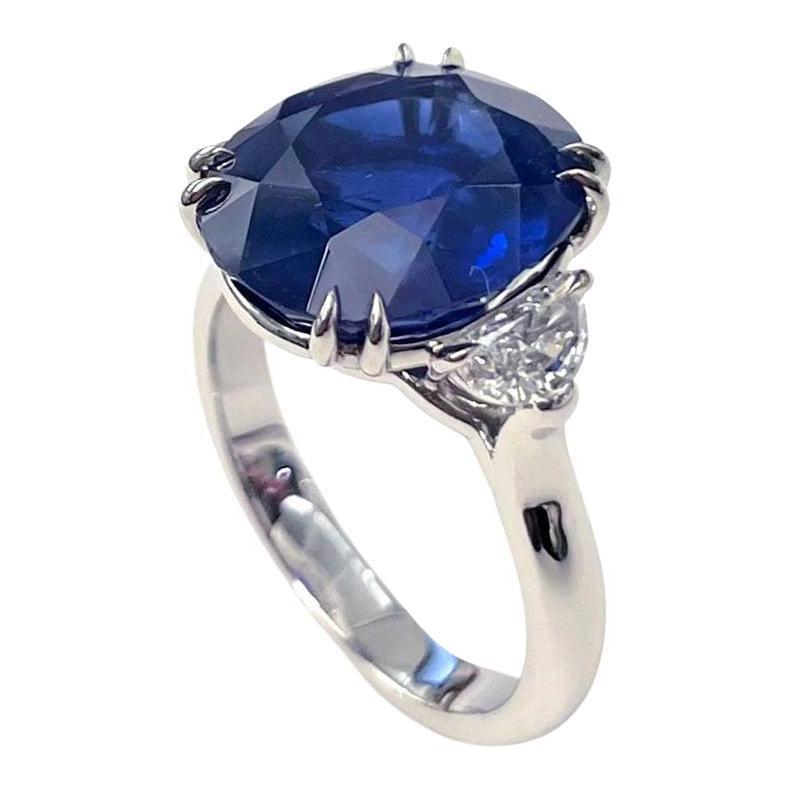Ceylon sapphire and diamond ring, featuring an oval-shaped natural sapphire weighing 8.59 carats flanked by two half moon-shaped diamonds, in a platinum setting. Two diamonds weighing 0.55 total carats (E-F color, VS1-VS2 clarity). Accompanied by