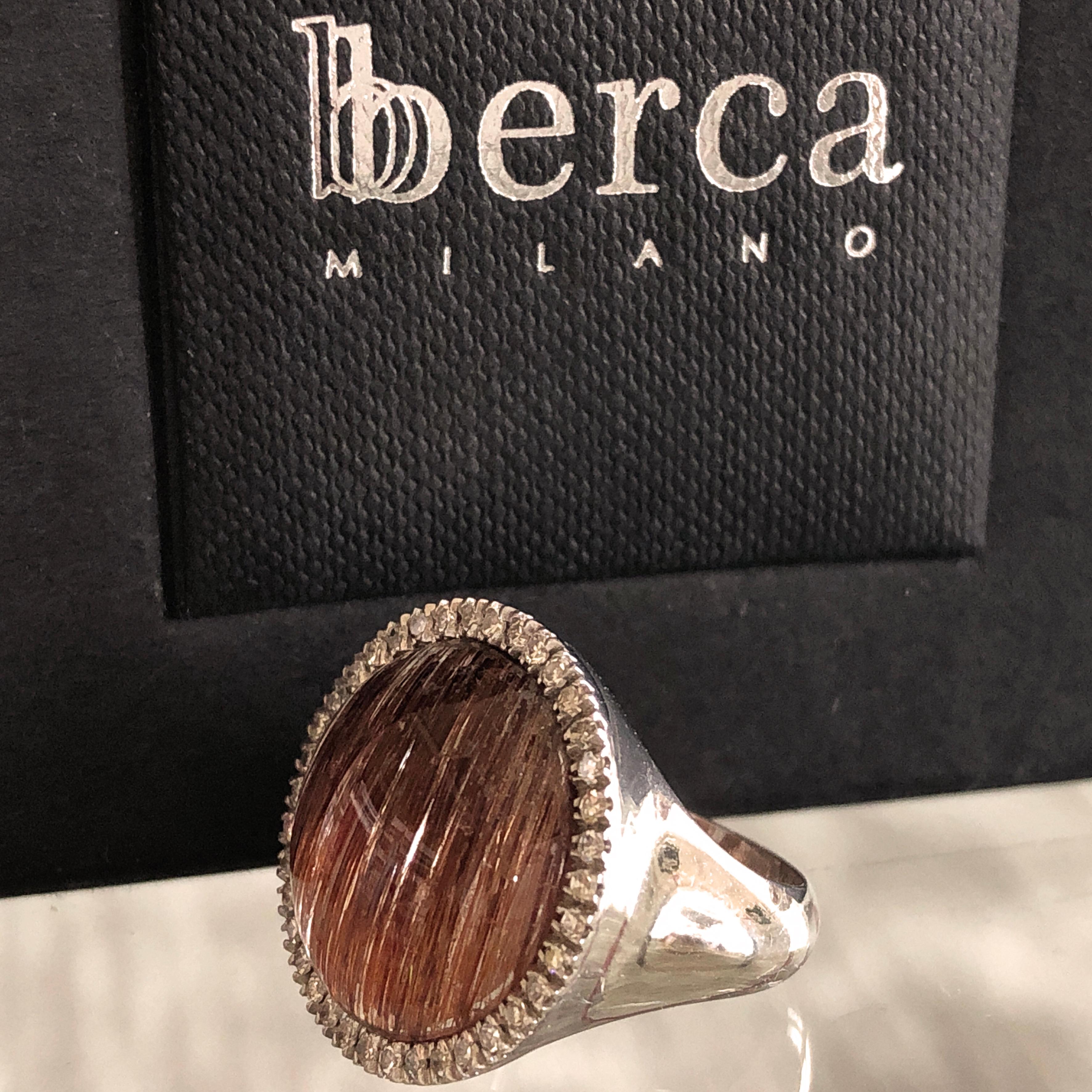 An One-of-a-kind Contemporary Pinkie Cocktail Ring featuring an 8.50 Carat Round Cabochon Cut Cinnamon Rutilated Quartz in a 0.41 Carat White Diamond White Gold Setting. 
The color-changing of this unusual Rutilated Quartz creates a magical,