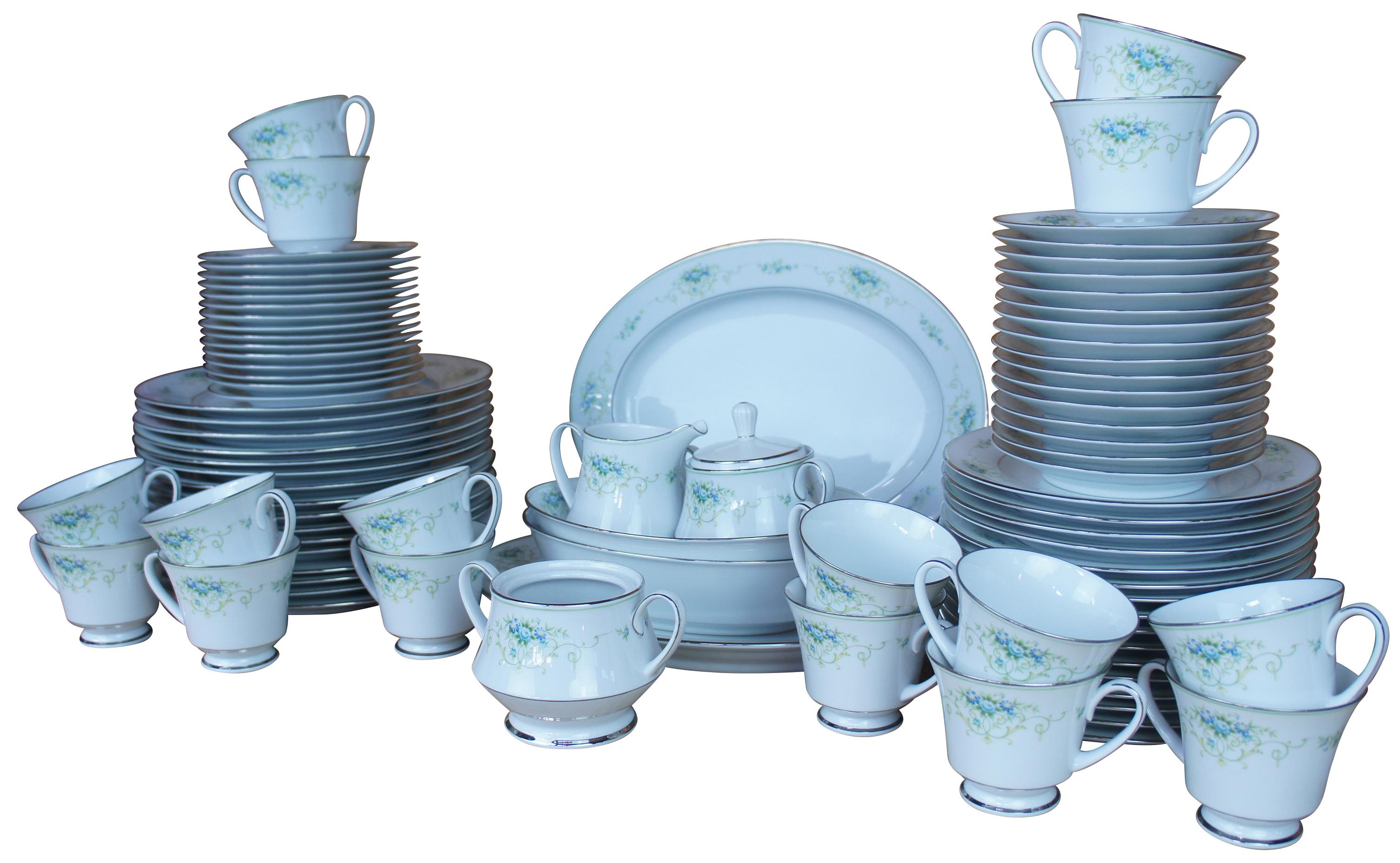 Set of thirty two vintage Noritake Sri Lanka Culeton 2692 dinner and salad plates featuring silver rim with a floral motif of blue, green and yellow.

