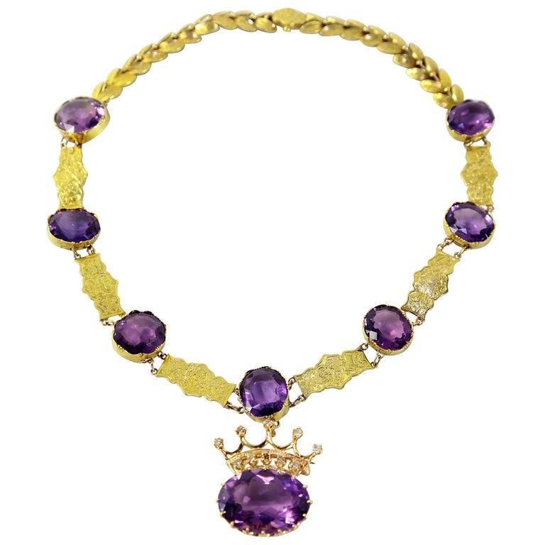 Simply Beautiful! Edwardian Crown necklace majestically set with 86.07 carat Amethyst stones in 18 Karat yellow Gold mounting; inter-spaced with hand crafted and engraved rectangular bars and leaves. This Fabulous necklace has 8 oval Amethyst (20.50