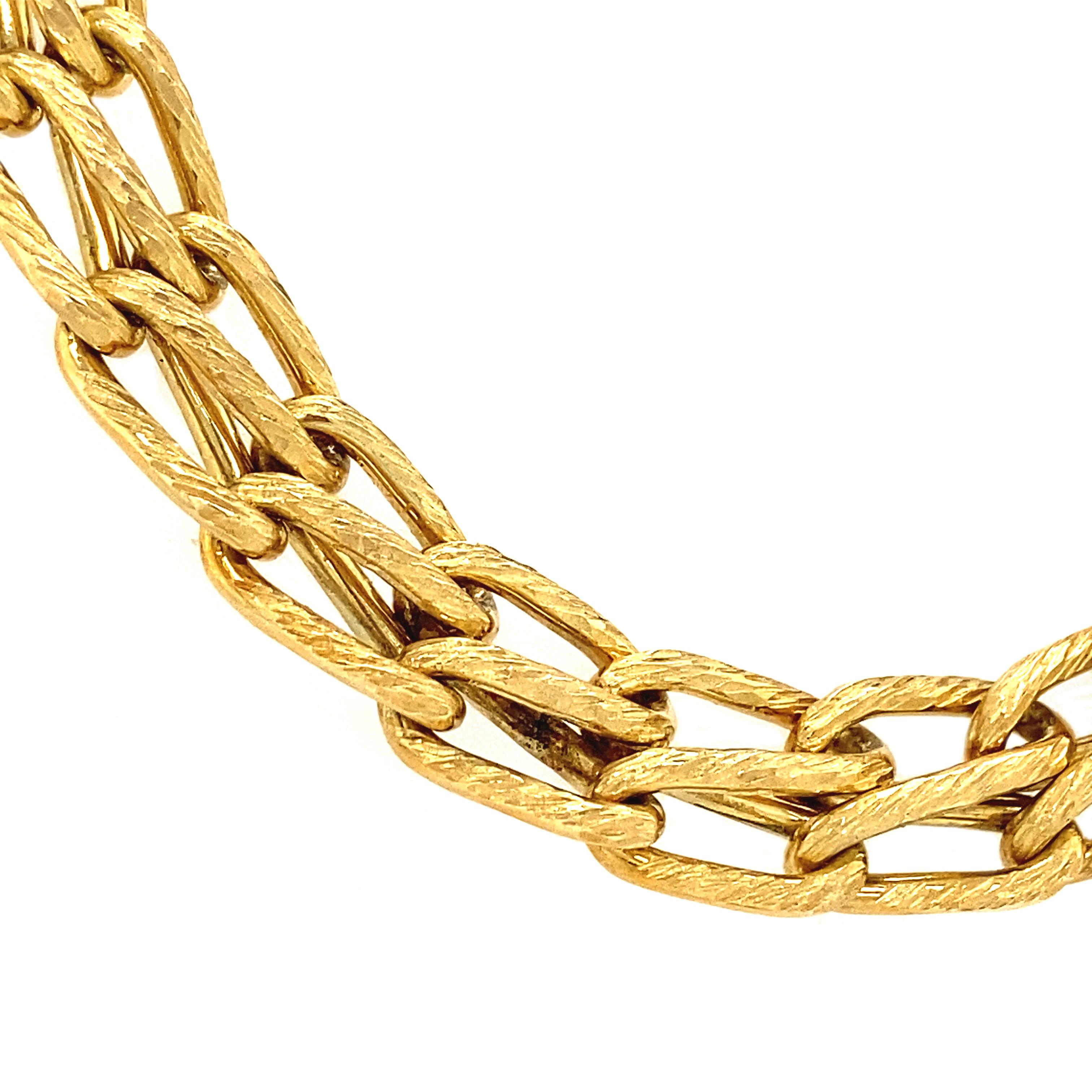 Weighing in at almost 100 grams of solid 14K yellow gold, this necklace is a superb vintage piece. Made of interlocked infinity links, the textured finish draws the eye and creates visual interest. Ideal as a solo statement piece, layered with your