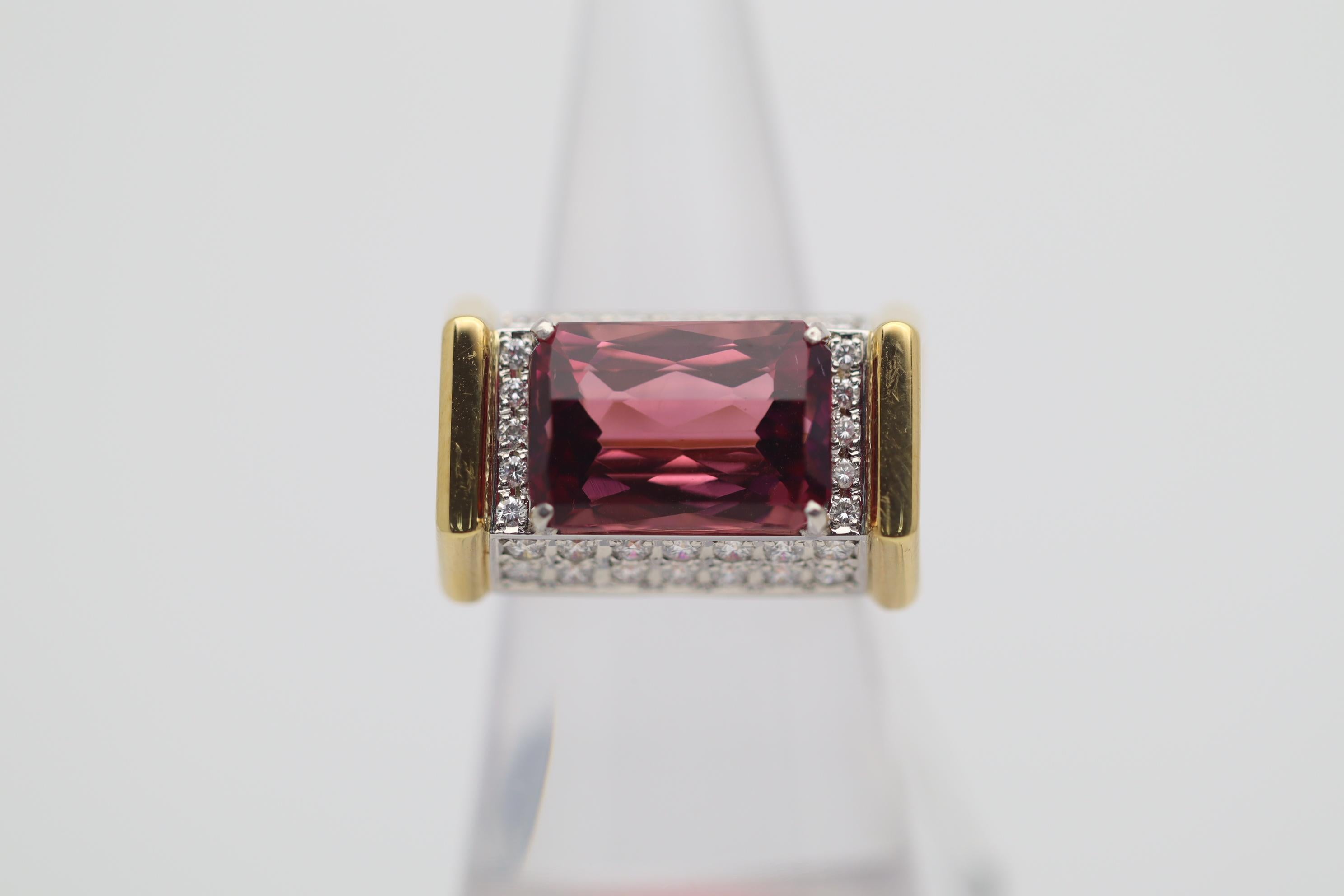 A fun and stylish platinum and gold ring featuring a very fine gemmy tourmaline. It weighs 8.63 carats and has a bright and intense pink color with excellent scintillation and light return. Additionally, there are 0.81 carats of bright white round