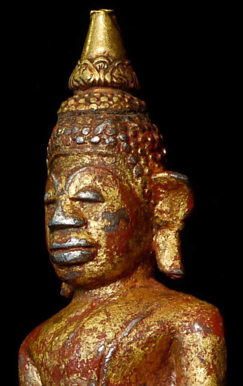 An extremely uncommon and very beautiful Cambodian Buddha. The body is made of nearly pure silver Buddha with a high-karat gold flame on the top of his head. Remains of lacquer and gilding are evident. Very beautiful face- with a profound serenity