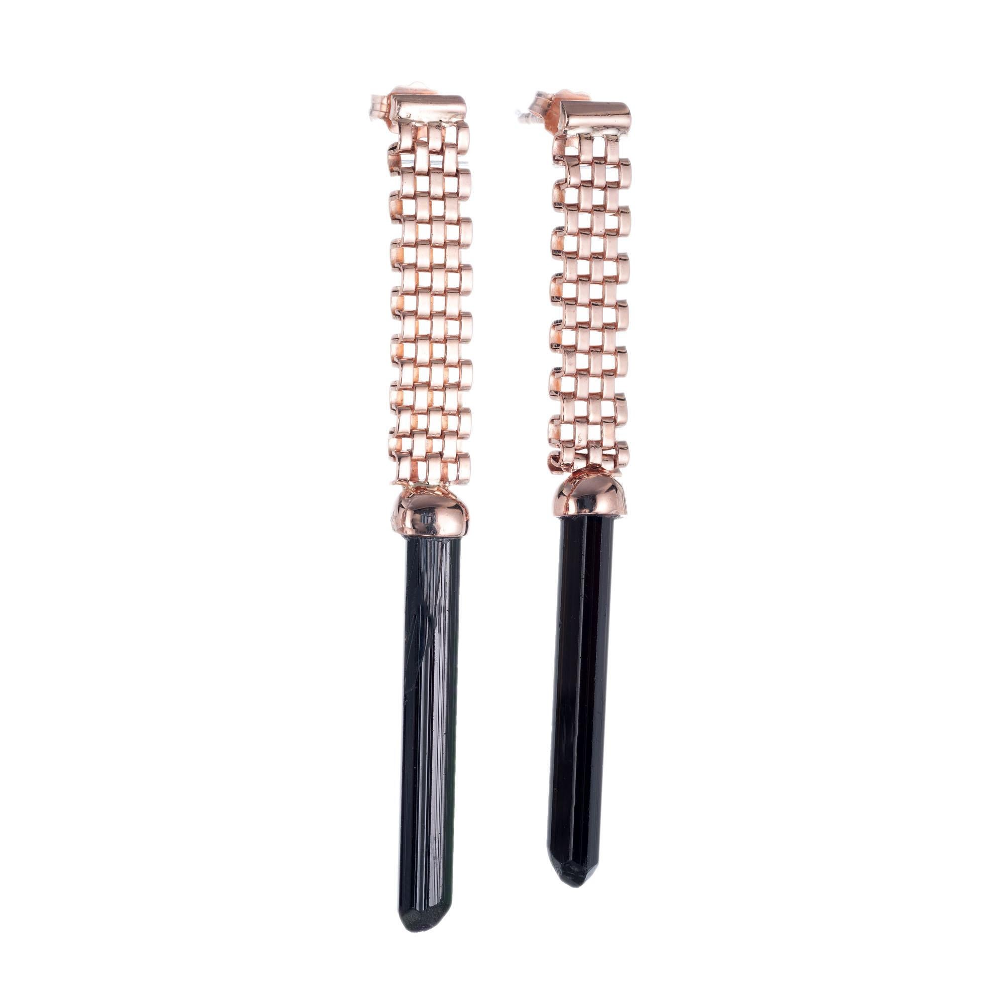 Natural untreated black tourmaline crystal dangle earrings with 14k rose gold mesh tops for pierced ears. Circa 1940

2 black tourmaline cylinders, SI-I approx. 8.66cts
14 rose gold 
Stamped: 585
6.1 grams
Top to bottom: 51.9mm or 2.25 Inch
Width: