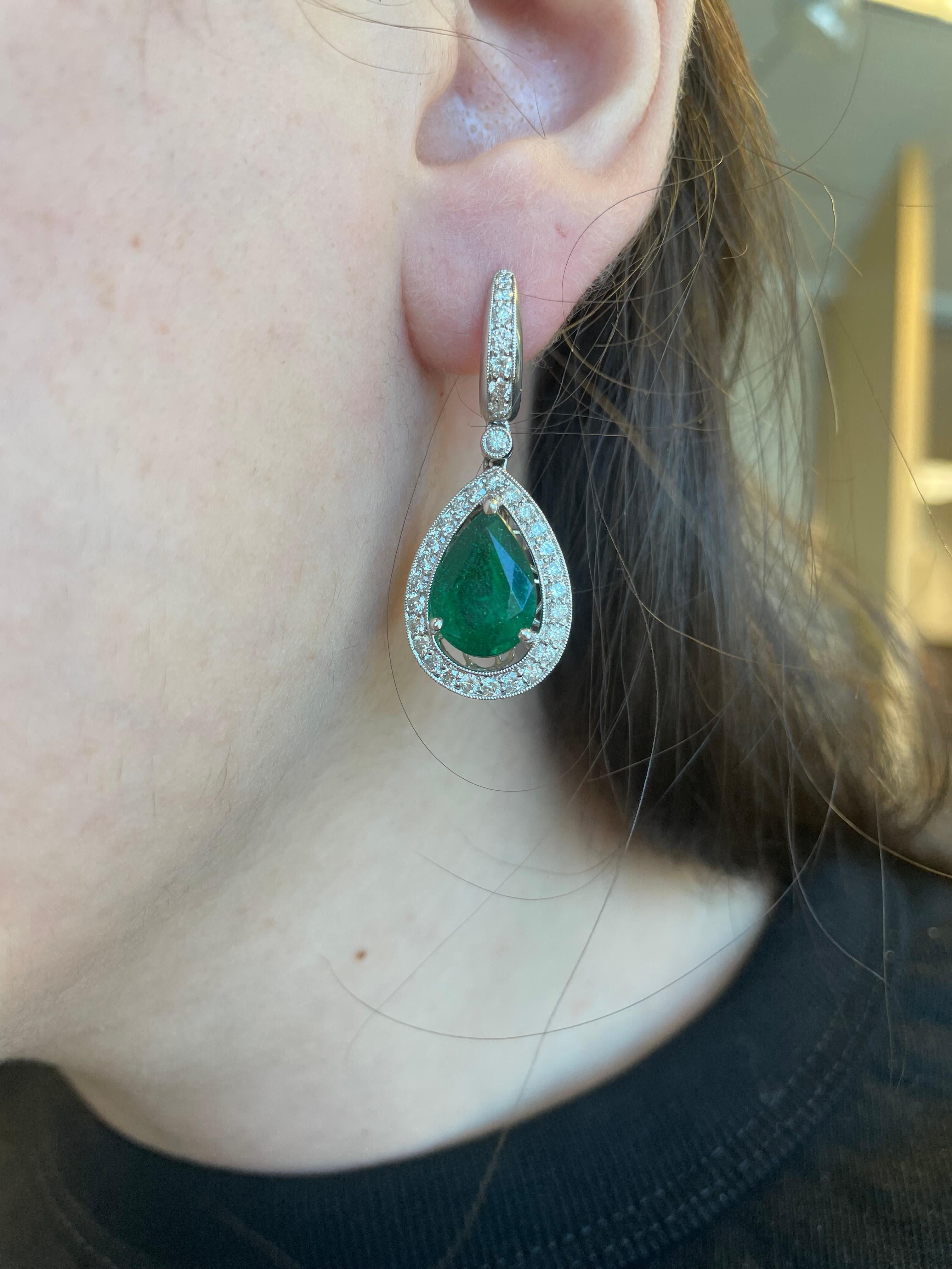 Sensational emerald and diamond halo drop earrings. Created by Alexander Beverly Hills.
10.32ct total gemstone weight. 
2 pear shape emeralds, 8.69 carats total, apx F2. Complimented by 1.63 carats of brilliant diamonds. Approximately G/H color and