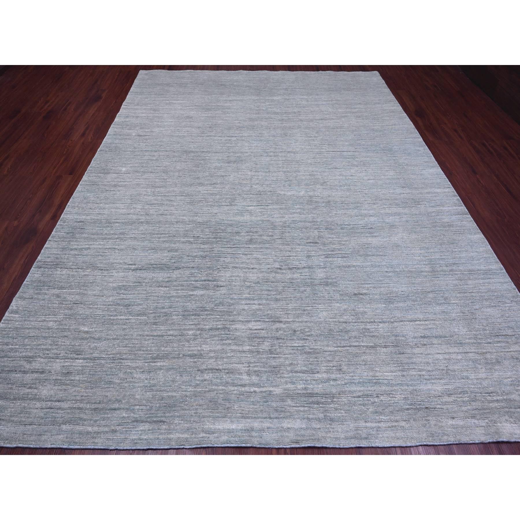 Cloud Gray, Hand Knotted, Plain Solid Pattern, Hand Spun Ghazni Wool, Lush and Plush, Oriental Rug
Primary materials: Wool
Latex: No Pile 
height: 0.25 Inches
Style: Contemporary
Primary color: Grey
Secondary colors: Light Blue
Pattern: Oriental