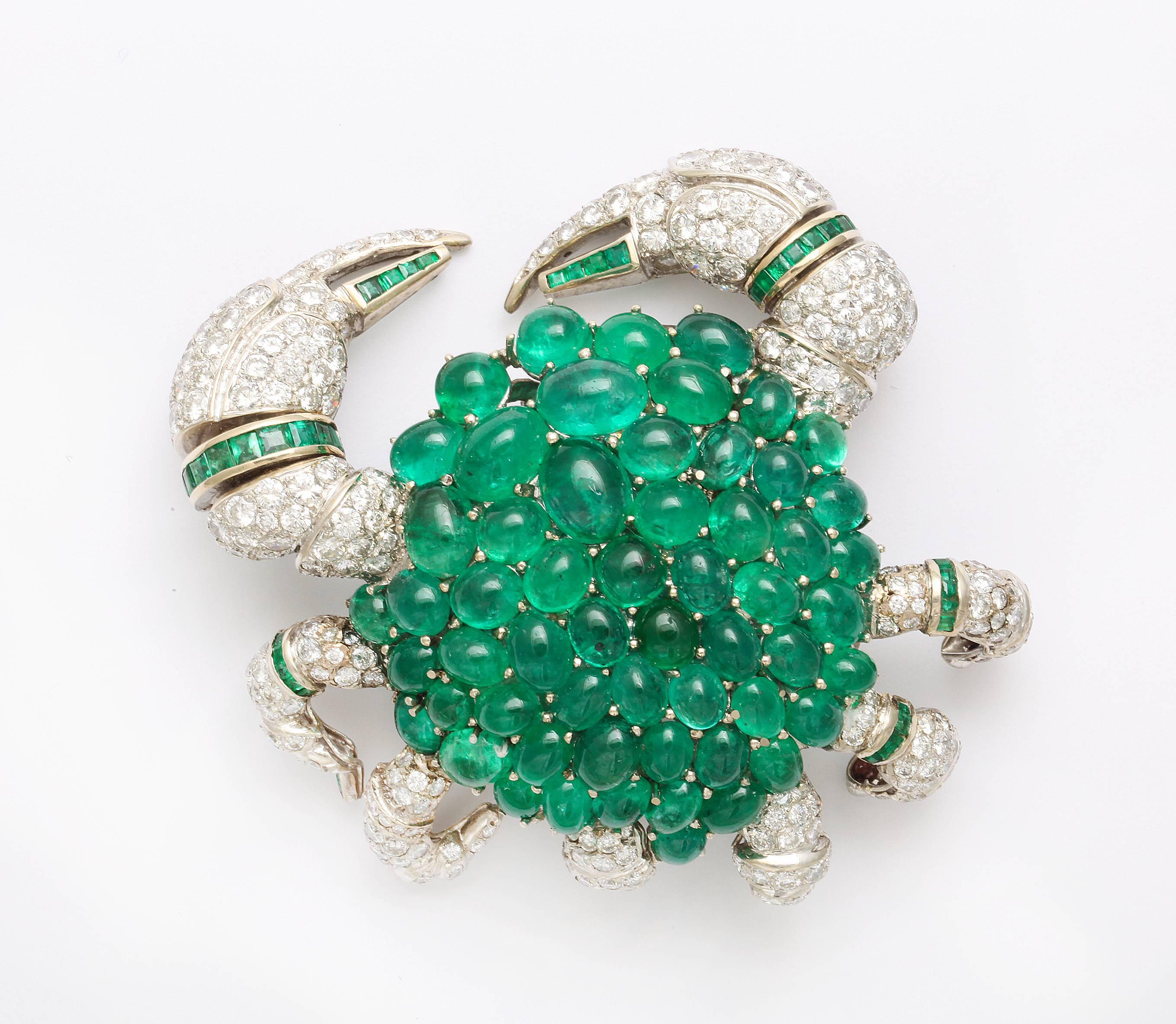 We offer this spectacular large scale brooch depicting a crab fashioned of 18K white gold with its shell surface set with approximately 87 carats of deep green oval cabochon emeralds and the legs set with 9.70 carats of round brilliant cut diamonds