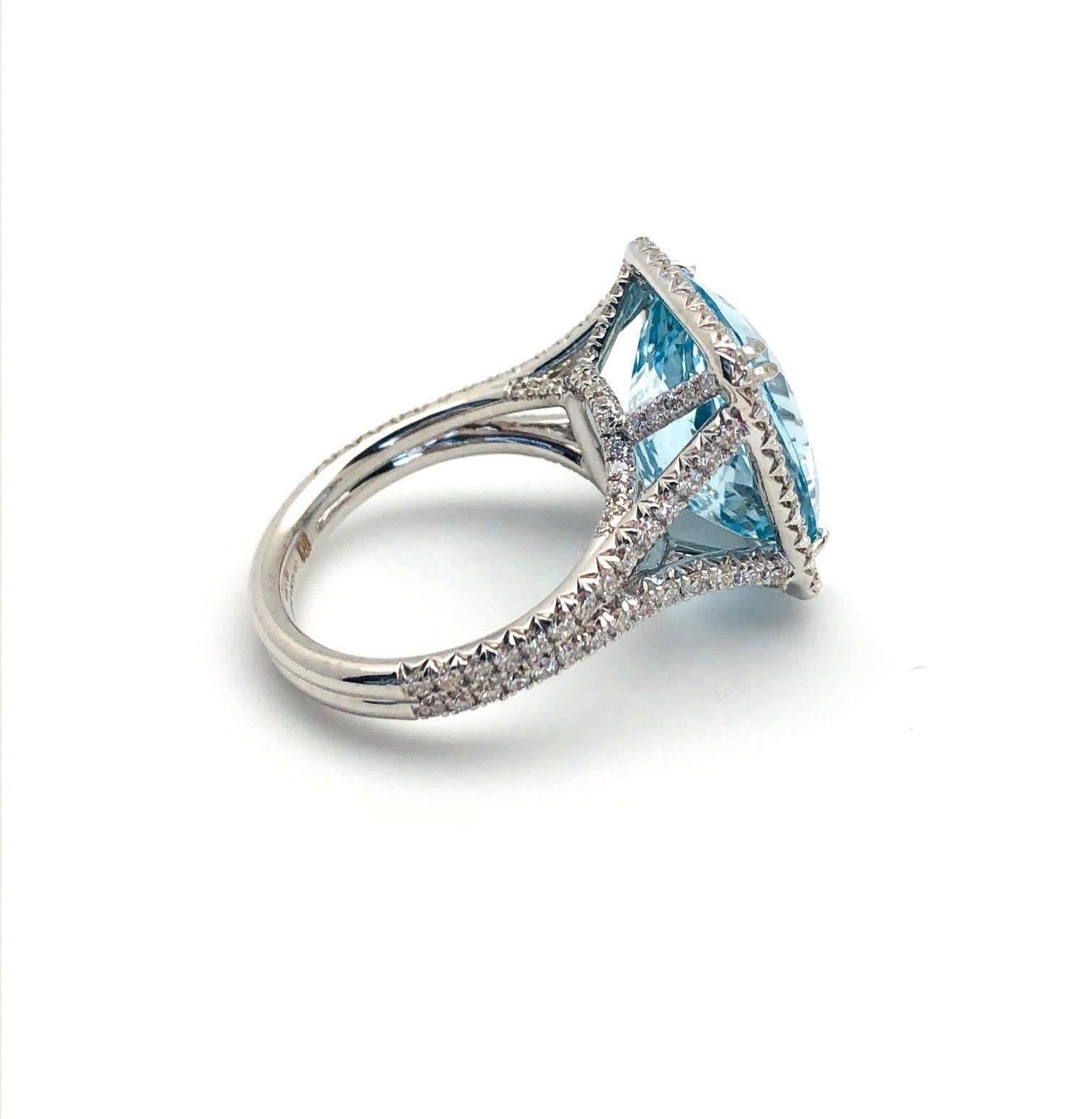 This spectacular aquamarine and diamond halo cocktail ring features a gorgeous 8.70 carat, crystalline blue aquamarine set in 18k white gold with over a carat in diamonds! The impressive center aquamarine is a real gem, with ideal color, a beautiful