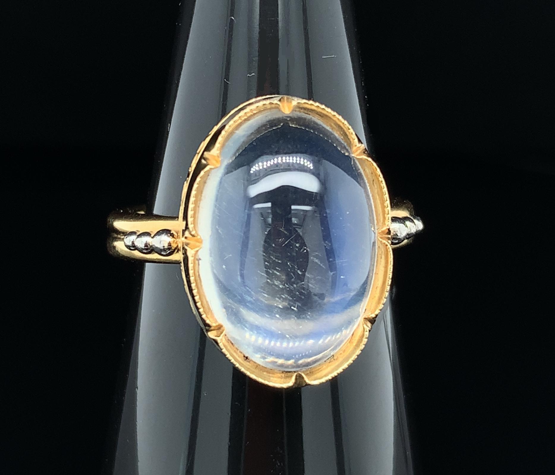 This pretty ring features a large oval moonstone weighing 8.70 carats with beautiful adularescence. Adularescence, or 