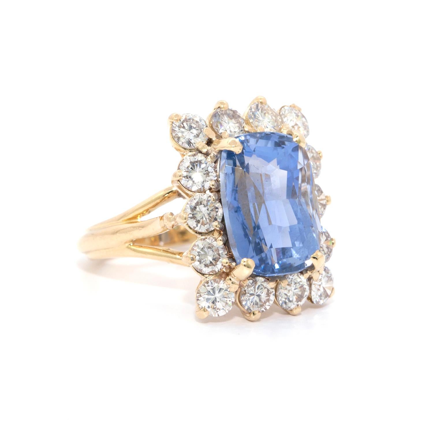 Sapphire and Diamond 18k yellow gold cocktail ring featuring a 8.70 ct cushion shaped Sapphire which is surrounded by 14 rbc white SI1 plus diamonds that weigh in total 2.10 carats.   Size 4. Complimentary sizing 
