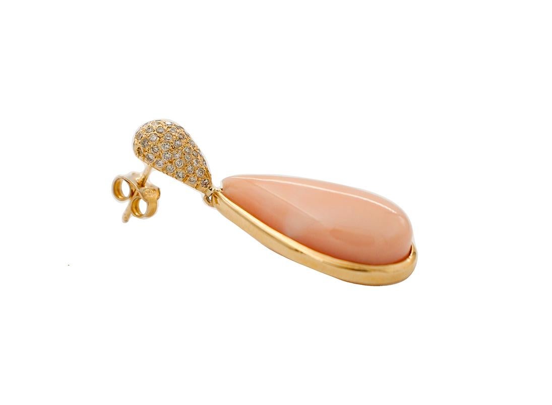 Amazing and elegant pair of drop retrò earrings realized in 18K yellow gold, composed at the top by a drop shape 18K yellow gold structure studded with 1.08 ct of little diamonds and at the bottom by 8.70 g of angel skin pink coral drops ( length 24