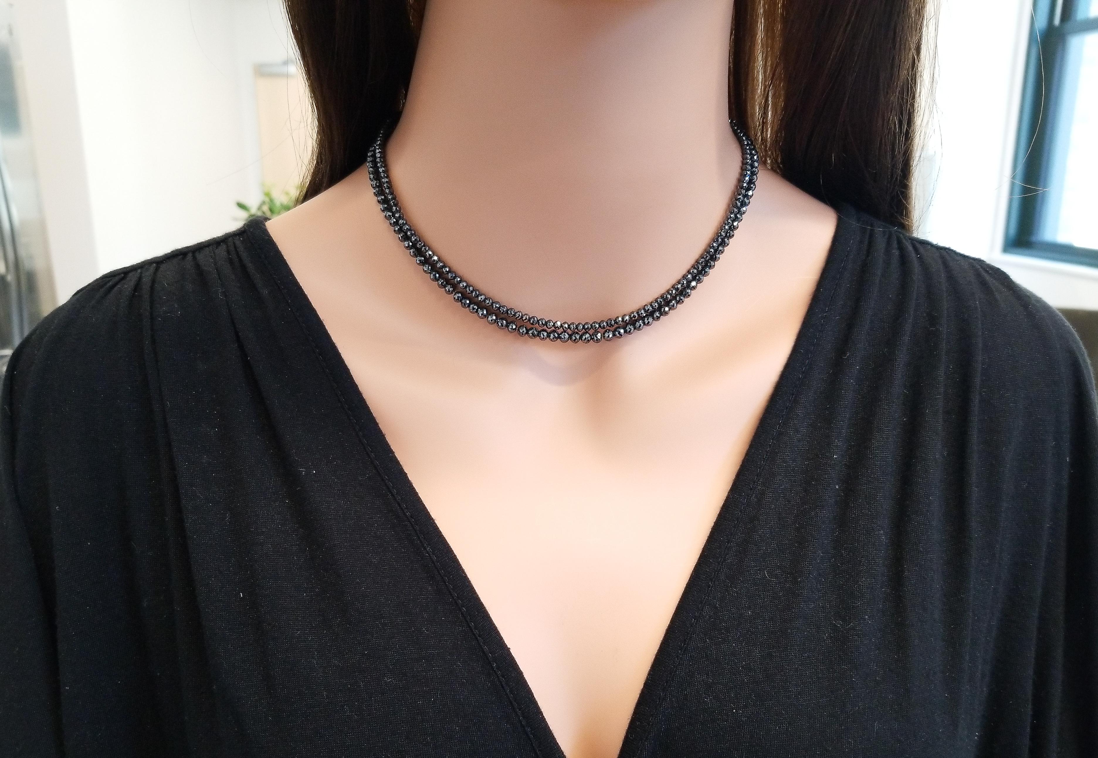 This 87.00 carat double strand, layering necklace is styling and features a grand total of 87 faceted briolette diamonds in two different lengths. These shimmering black diamonds are arranged with the largest beads on the outer layer allowing them