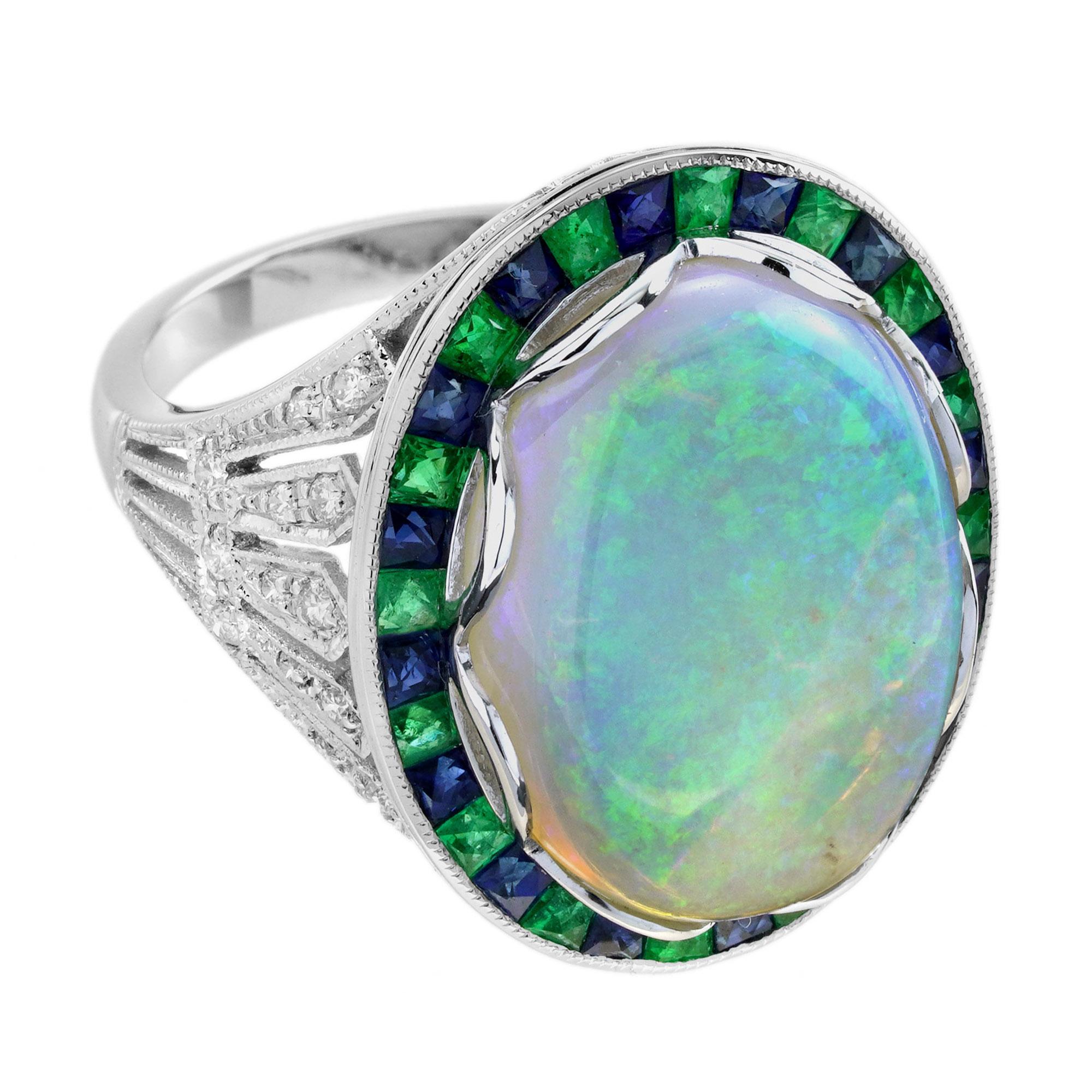 Radiating vintage charm, this Art Deco style cocktail ring features a luminous opal at the center.Encircled by vivid French-cut emeralds, the design glows with color and elegance.Diamond-accented shoulders add sparkle and sophistication to every