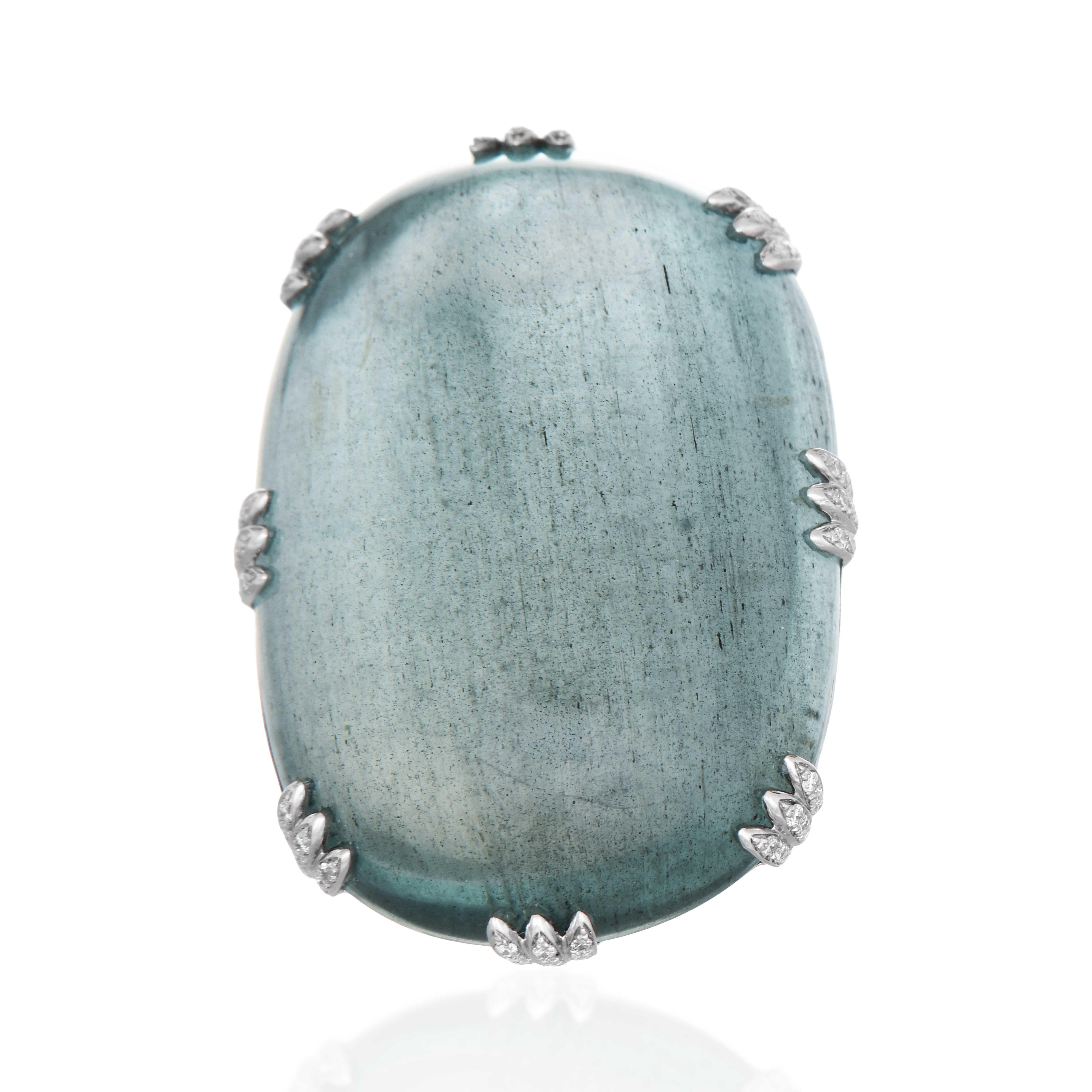 This stunning ring features a large, aquamarine gemstone set in sleek white gold. The striking design is enhanced with intricate diamond detailing around the edges, creating a timeless piece that exudes elegance and grace. Perfect for special