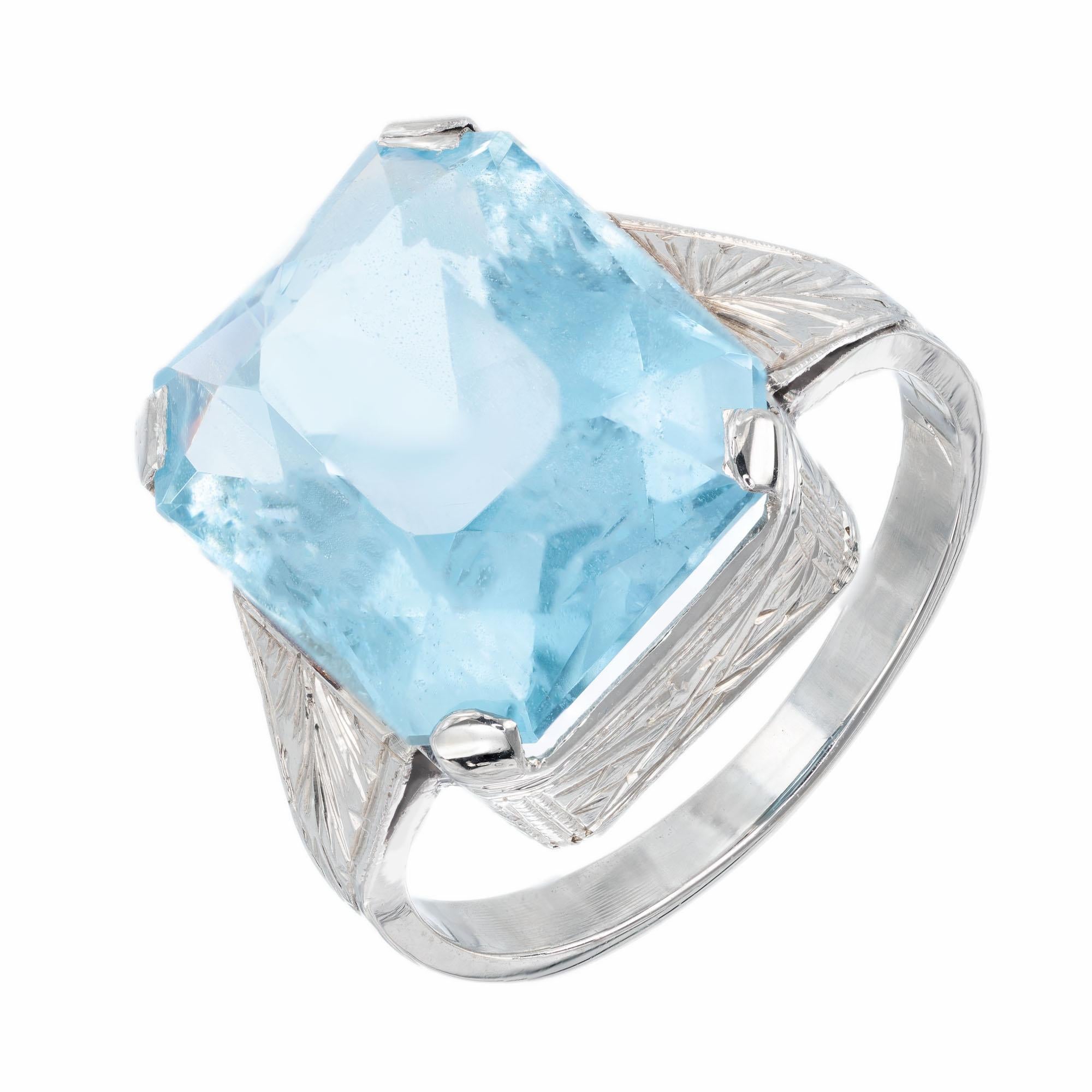 Circa 1920's Art Deco emerald cut aquamarine center stone in a 14k white gold handmade setting with hand engraved sides and shoulders. 

1 Emerald cut gem natural Aqua. approx. total weight 8.75cts, 14 x 11.9mm
Size 7 and sizable
14k White