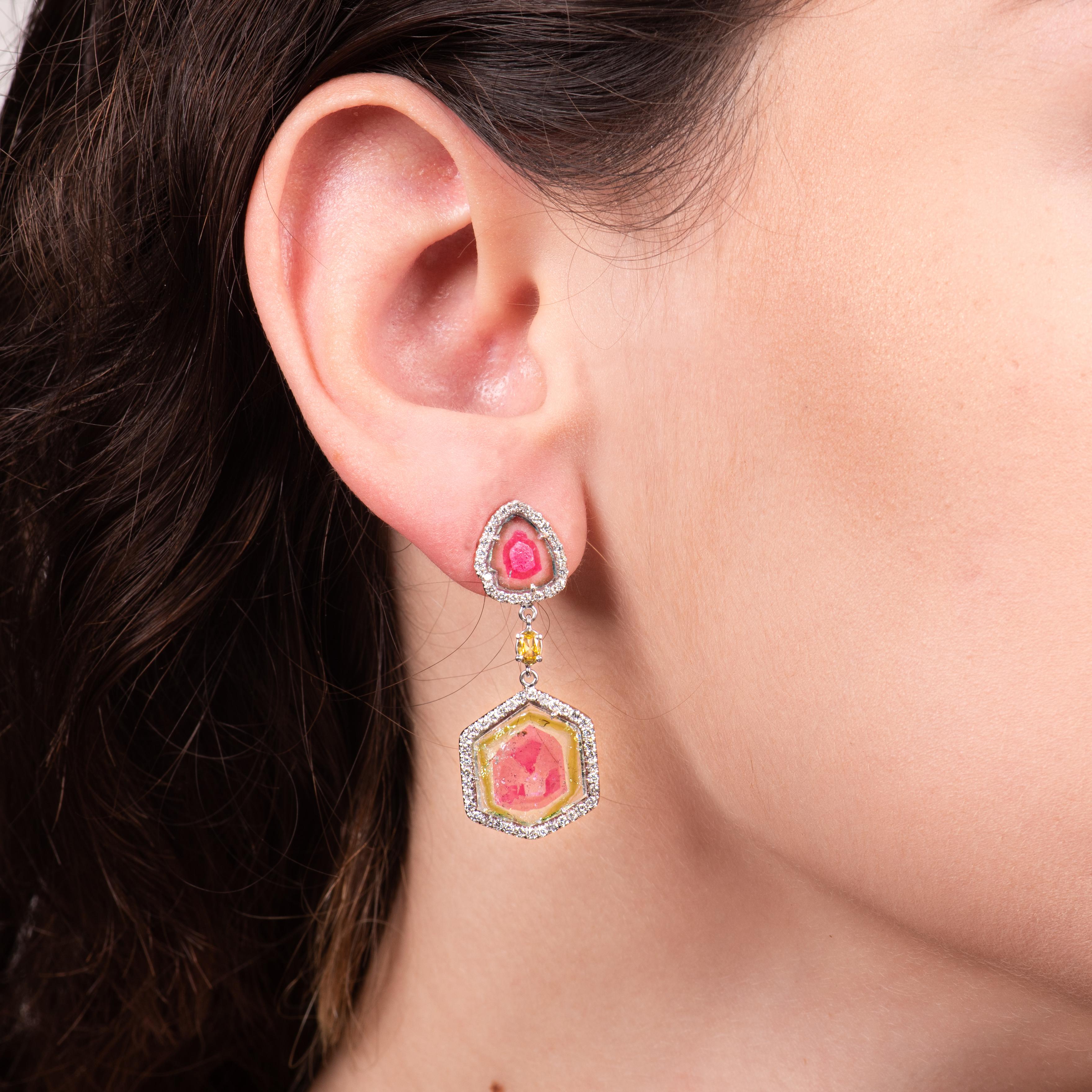 These earrings feature a 6.35ctw pair of natural watermelon tourmaline slices, ranging from ~12.1 to 13.71mm, and 2.42ct total weight pair of natural tri-color watermelon tourmaline, ranging from ~7.5 to 9.00mm in diameter, set in 14kt white gold