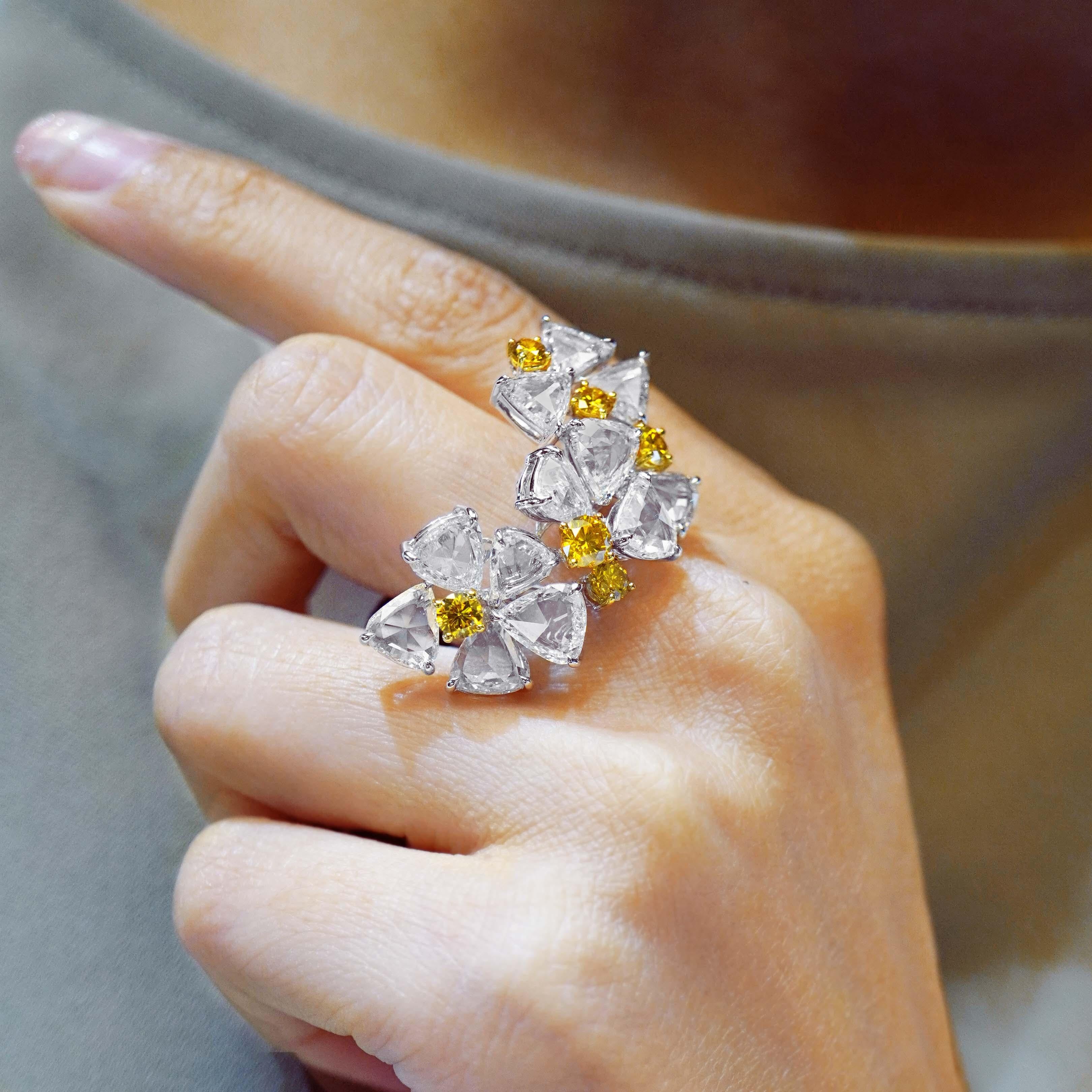 A gorgeous combination of 8.79 carat of D color white diamond are set along with 1.23 carat fancy vivid yellow round diamond. Its a perfect combination of lovers of both white diamond and connoisseur of fancy color diamond . 
The details of the ring